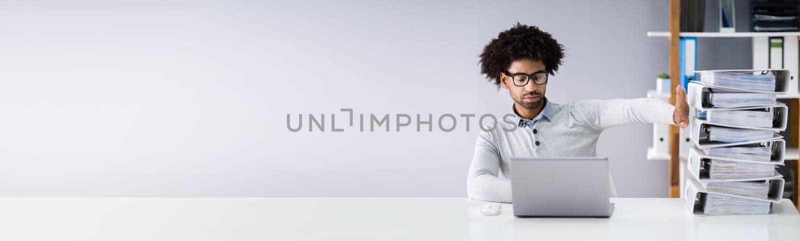 Businessperson Pushing Paper Documents Away And Working With Digital Documents On Computer Instead