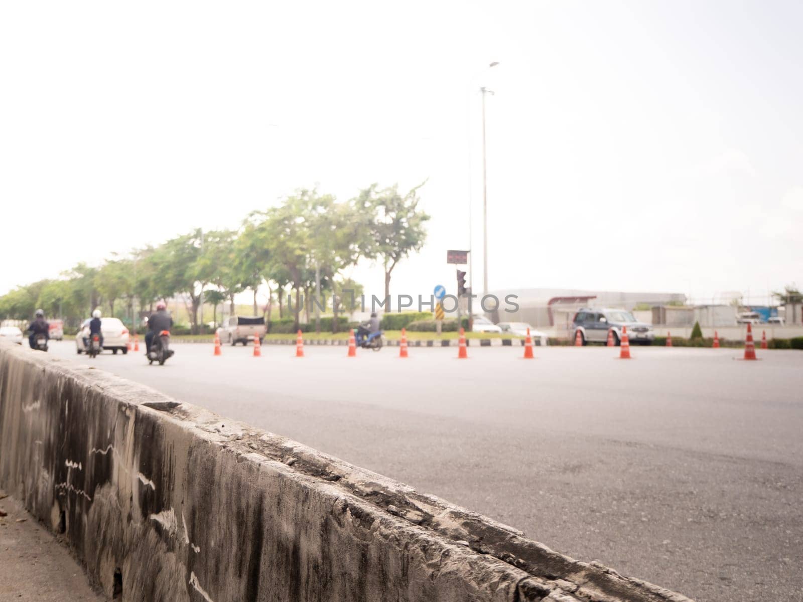 Highway traffic in sunset. Road with metal safety barrier or rail.