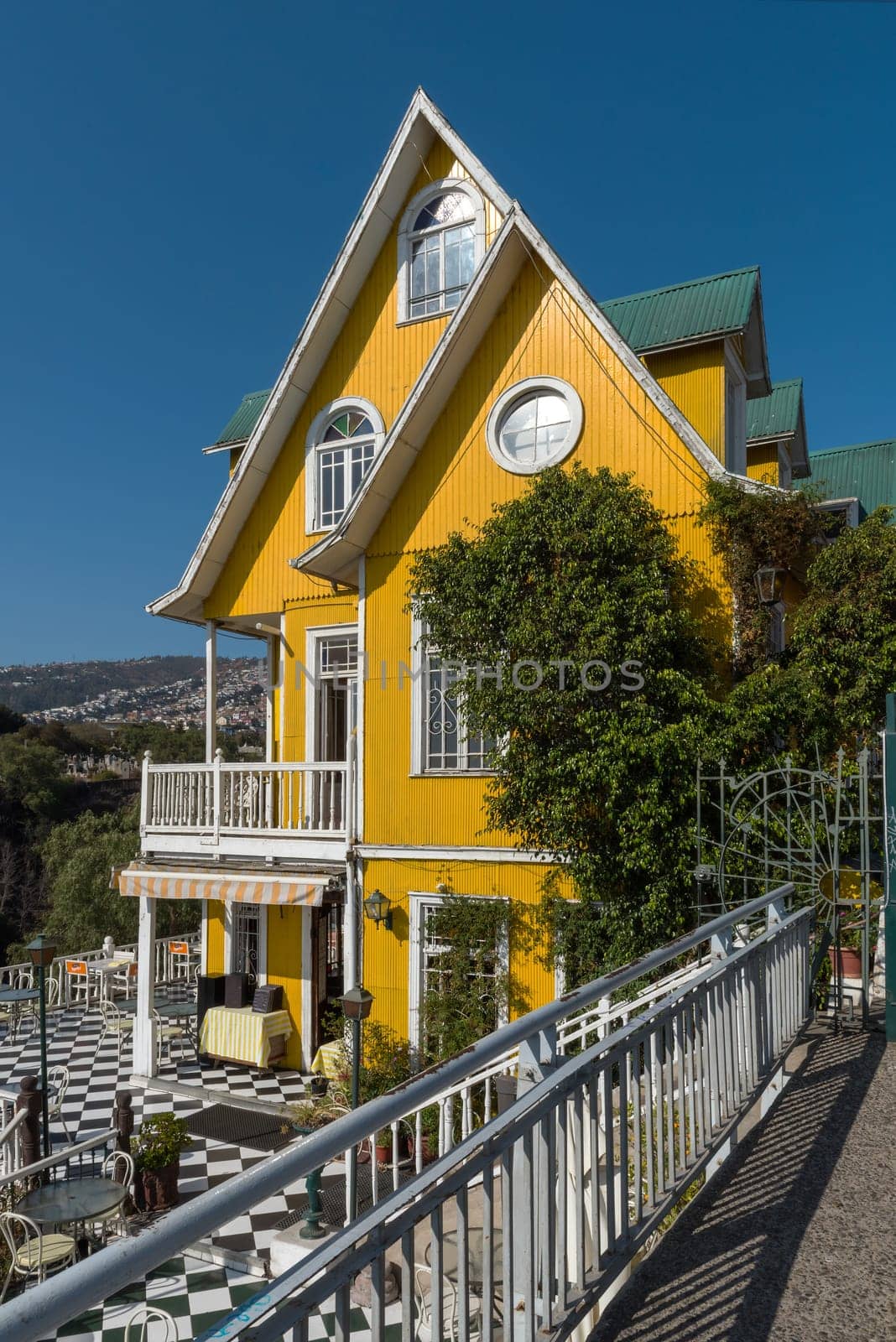 Beautiful traditional yellow wooden building in Valparaiso, Chile