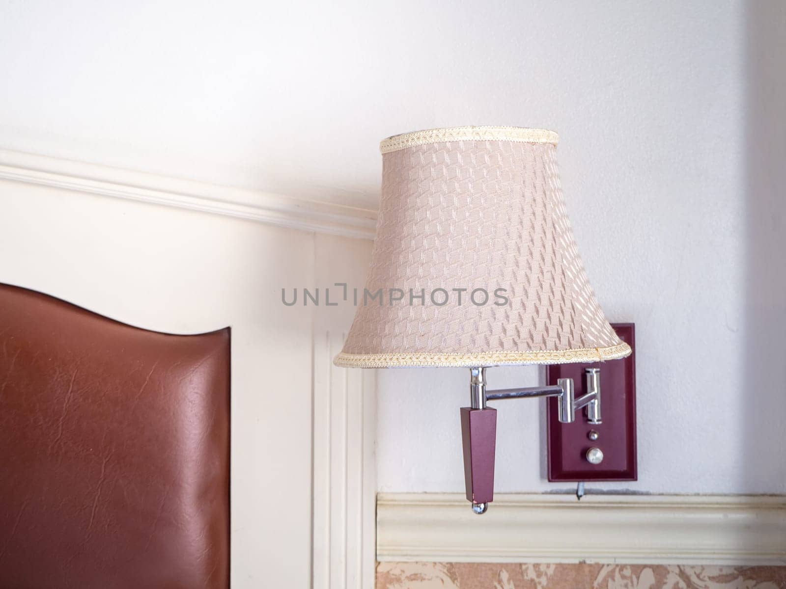bedroom interior with pillows and reading lamp on bedside table