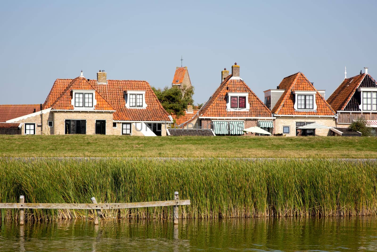 Historic houses behind te dike in Makkum, the Netherlands..