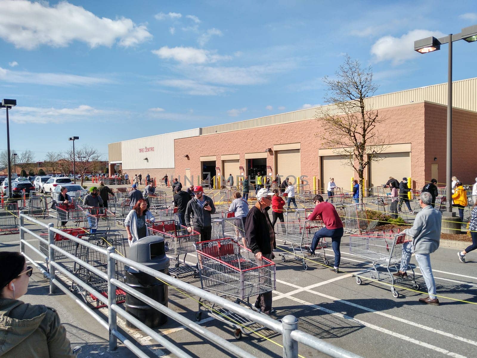 LANGLEY, CANADA - April 14, 2020. Shoppers line up in a giant costco shopping cart maze in order to get into the store during Covid-19 on April 14, 2020.