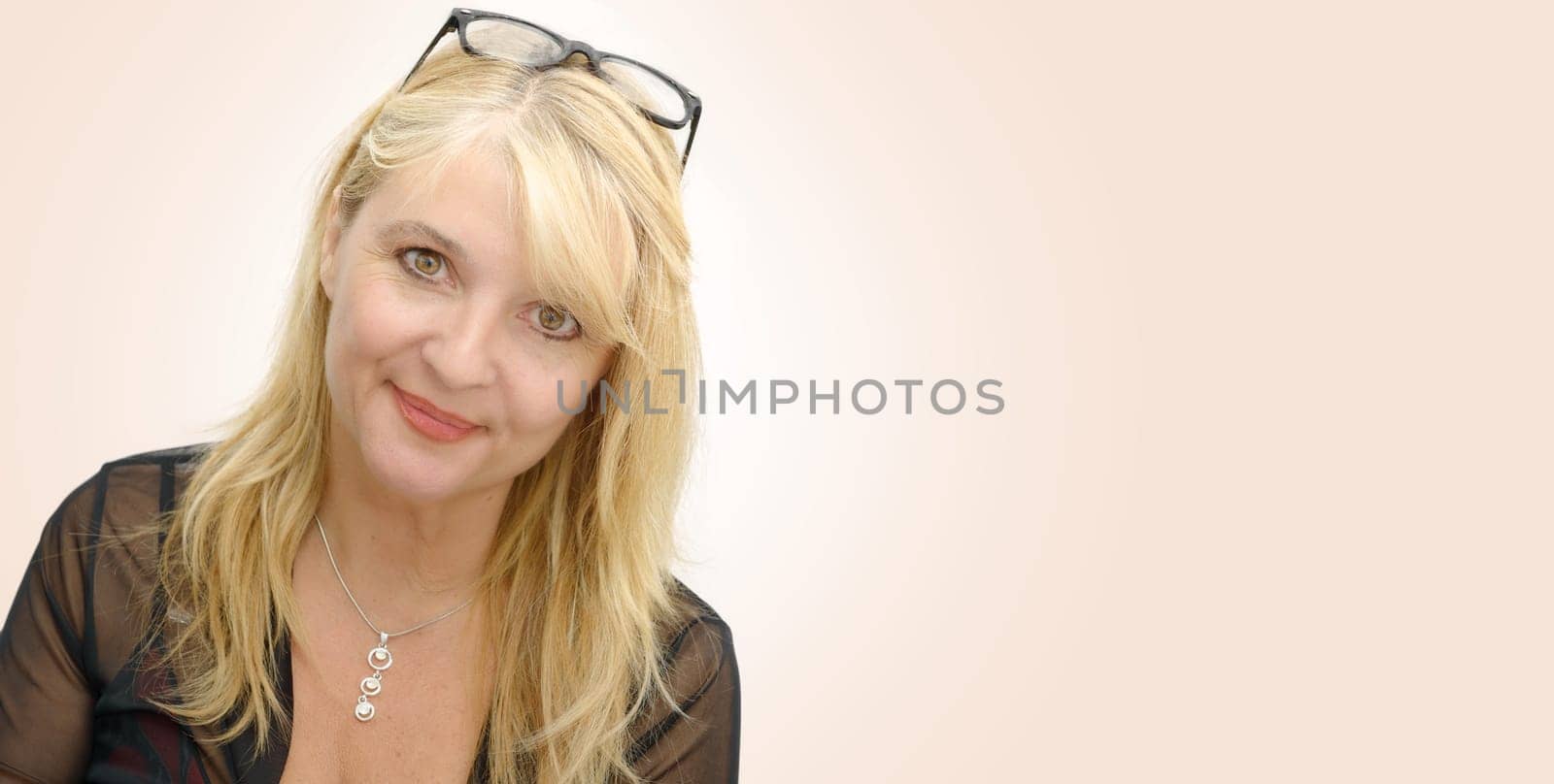 a portrait of mature smiling blond woman