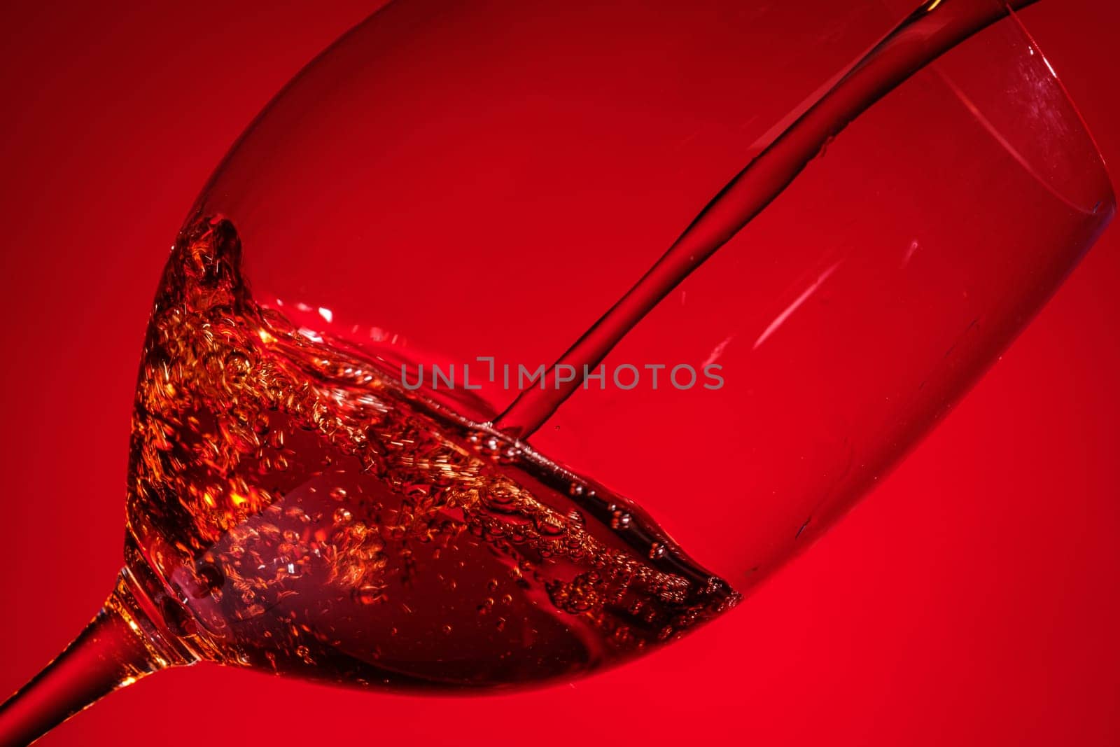 Pouring red wine in a transparent glass