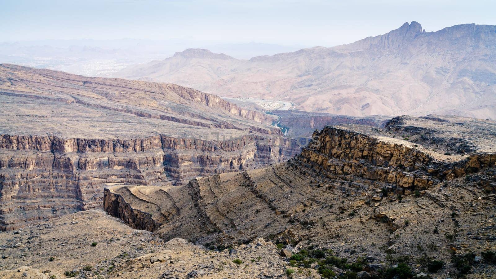 Scenic view of Wadi Ghul aka Grand Canyon of Arabia and surrounding landscape in Jebel Shams, Oman