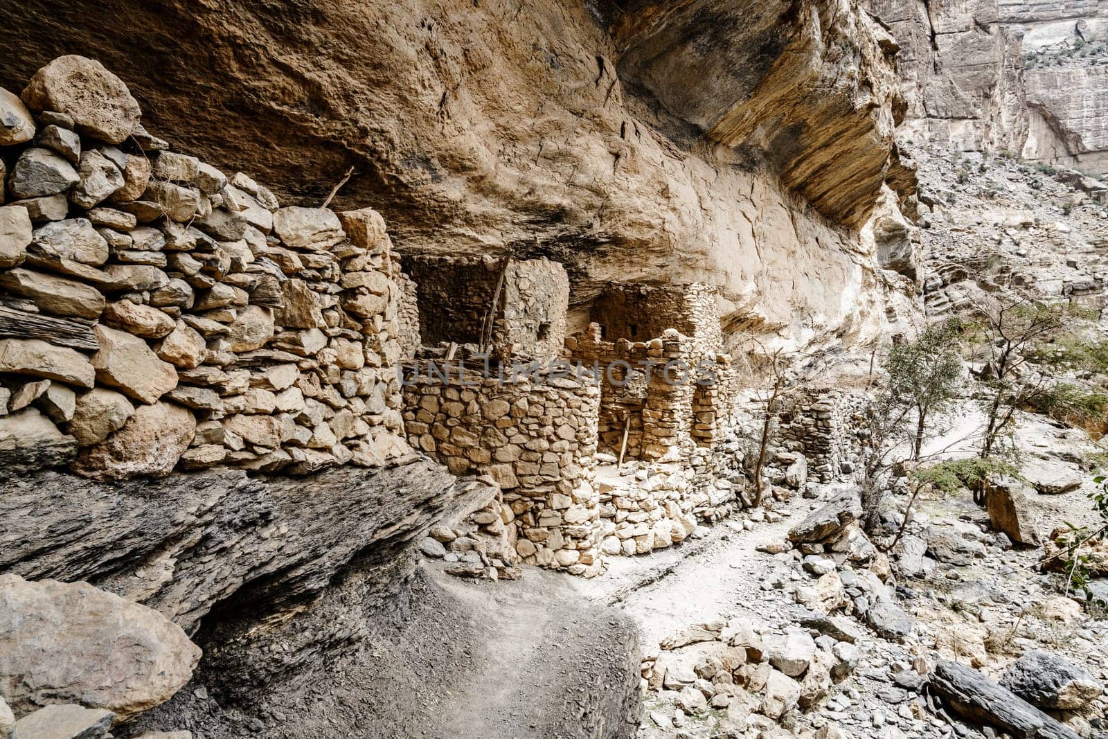 Ancient stone cliff dwellings in Wadi Ghul in Oman