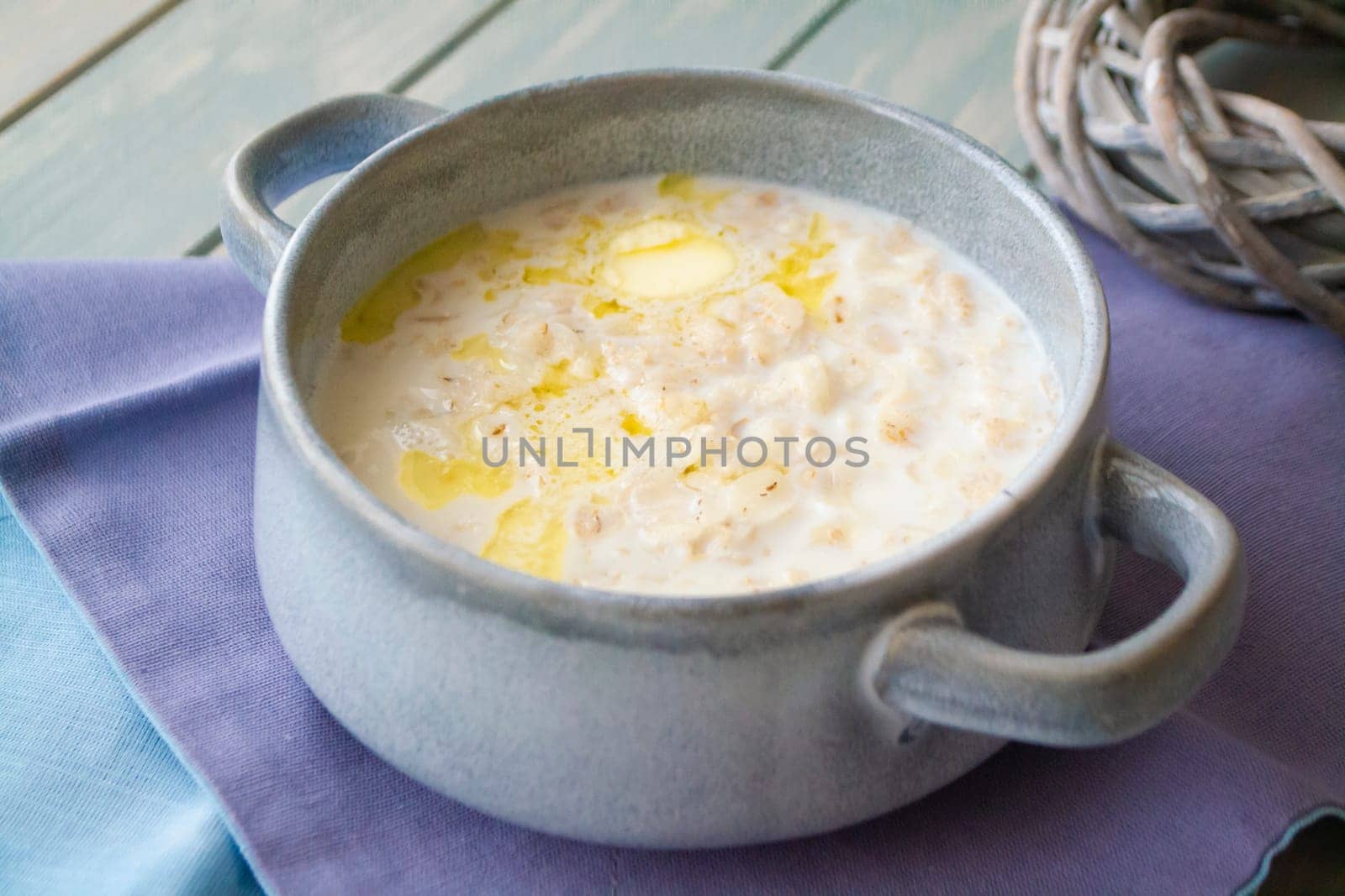 Milk soup with dough on wooden table close up
