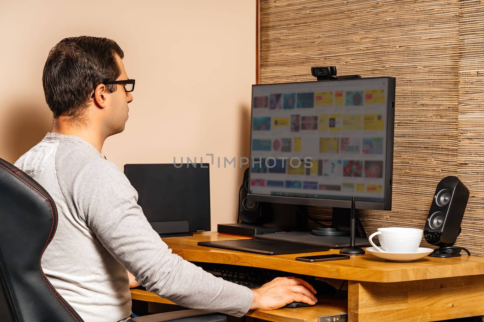 Middle age man working computer from comfort of his home during covid 19 or coronavirus pandemics, lockdown and quarantine