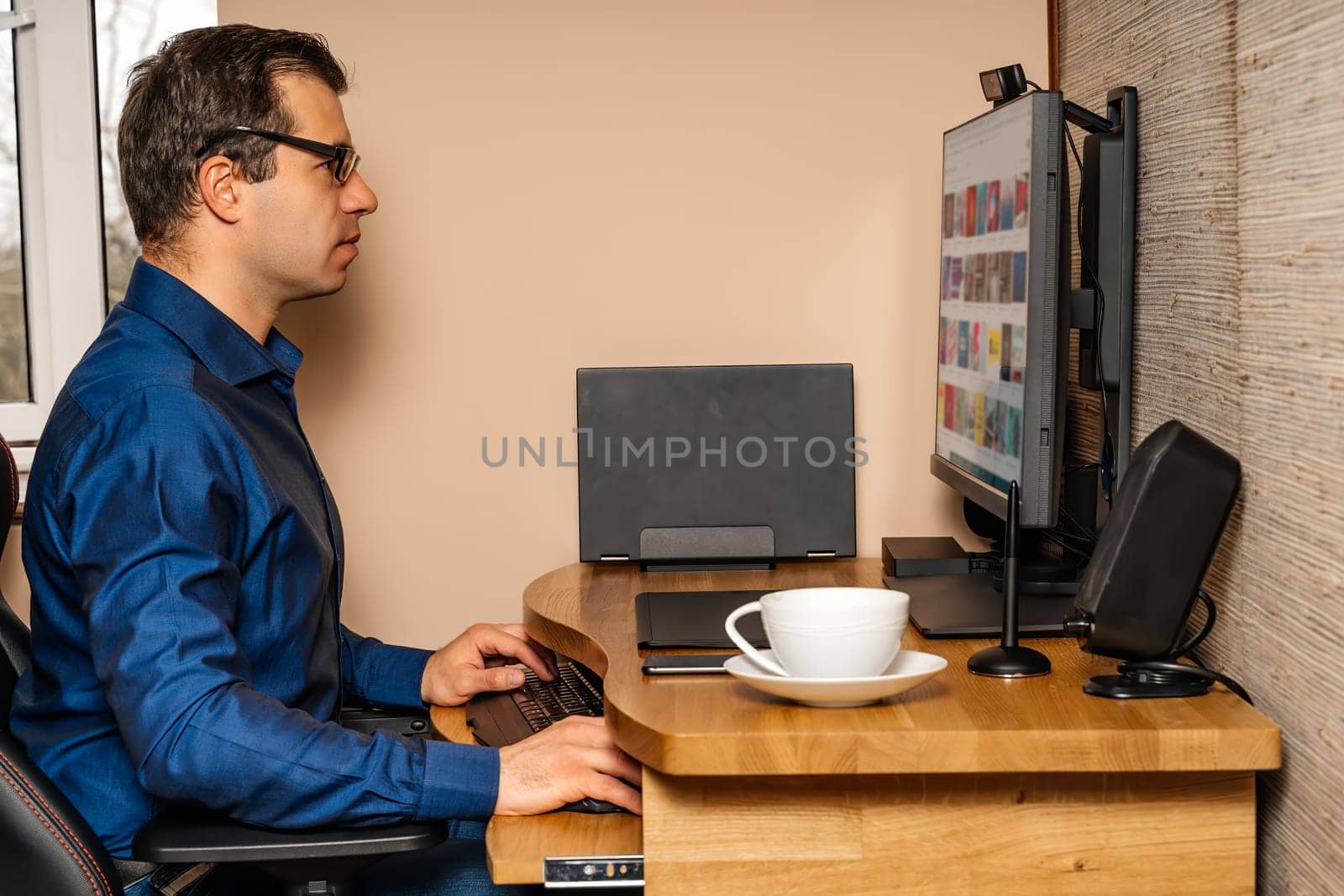 Middle age businessman working on computer from comfort of his home during covid 19 or coronavirus pandemics, lockdown and quarantine