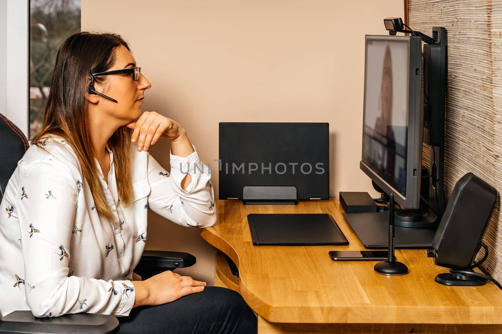 Businesswoman working on graphic tablet and computer from comfort of her home during covid 19 or coronavirus pandemics, lockdown and quarantine