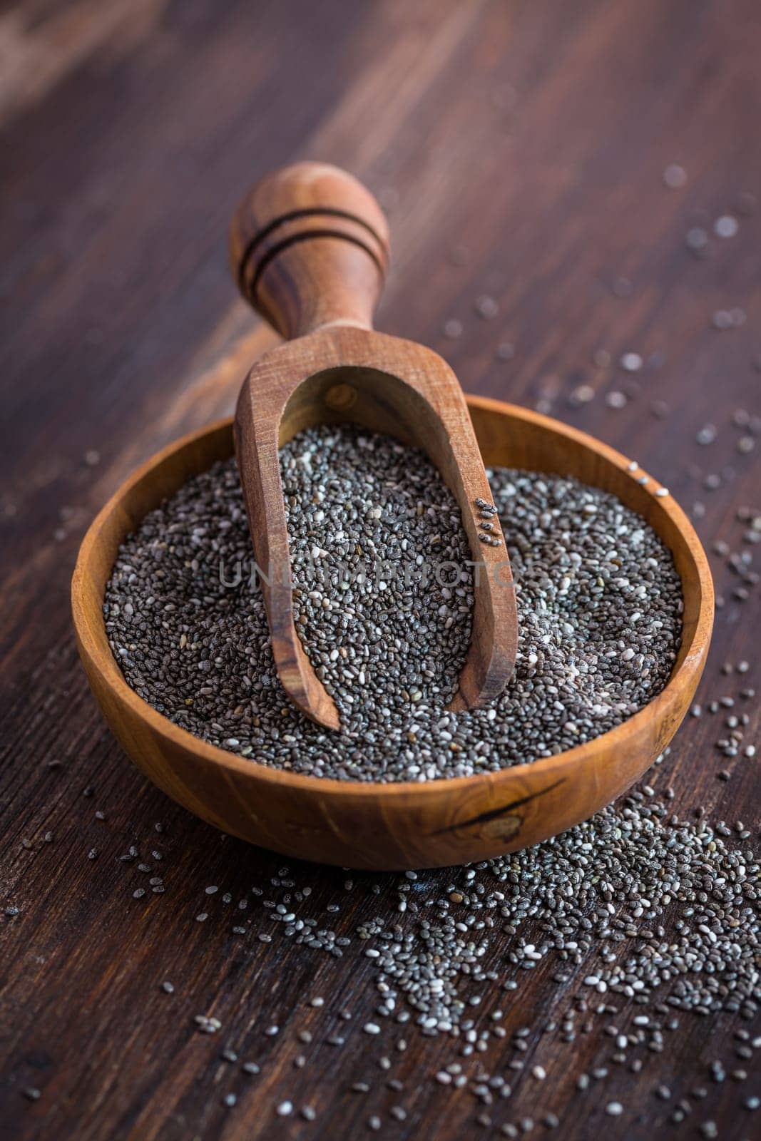 Nutritious Chia seeds with spoon in the bowl on the wooden background