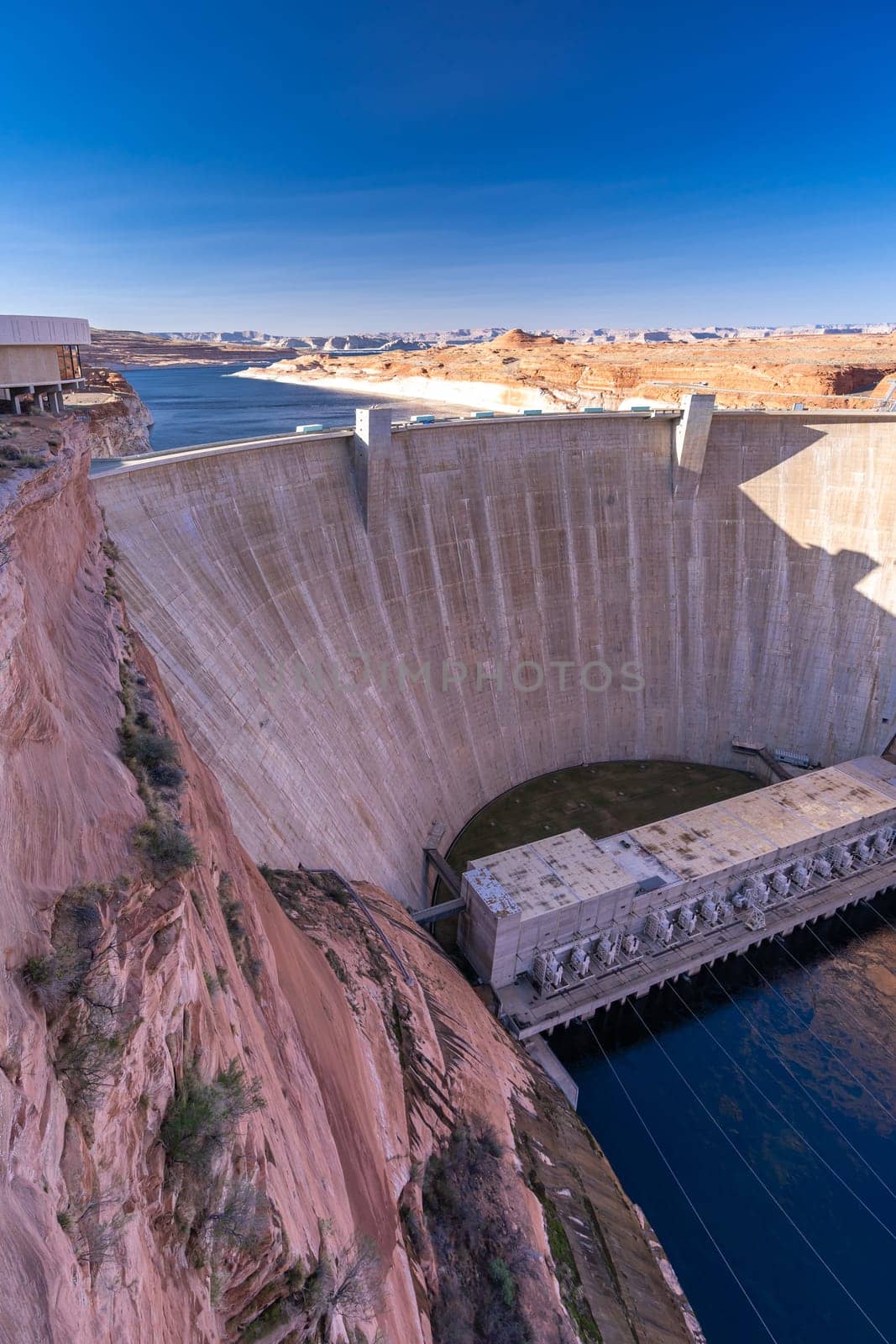 Glen Canyon Dam with Lake Powell in the Desert rural area of Page city Arizona, United States. USA Landmark environmental water resources reservoir and electricity concept.