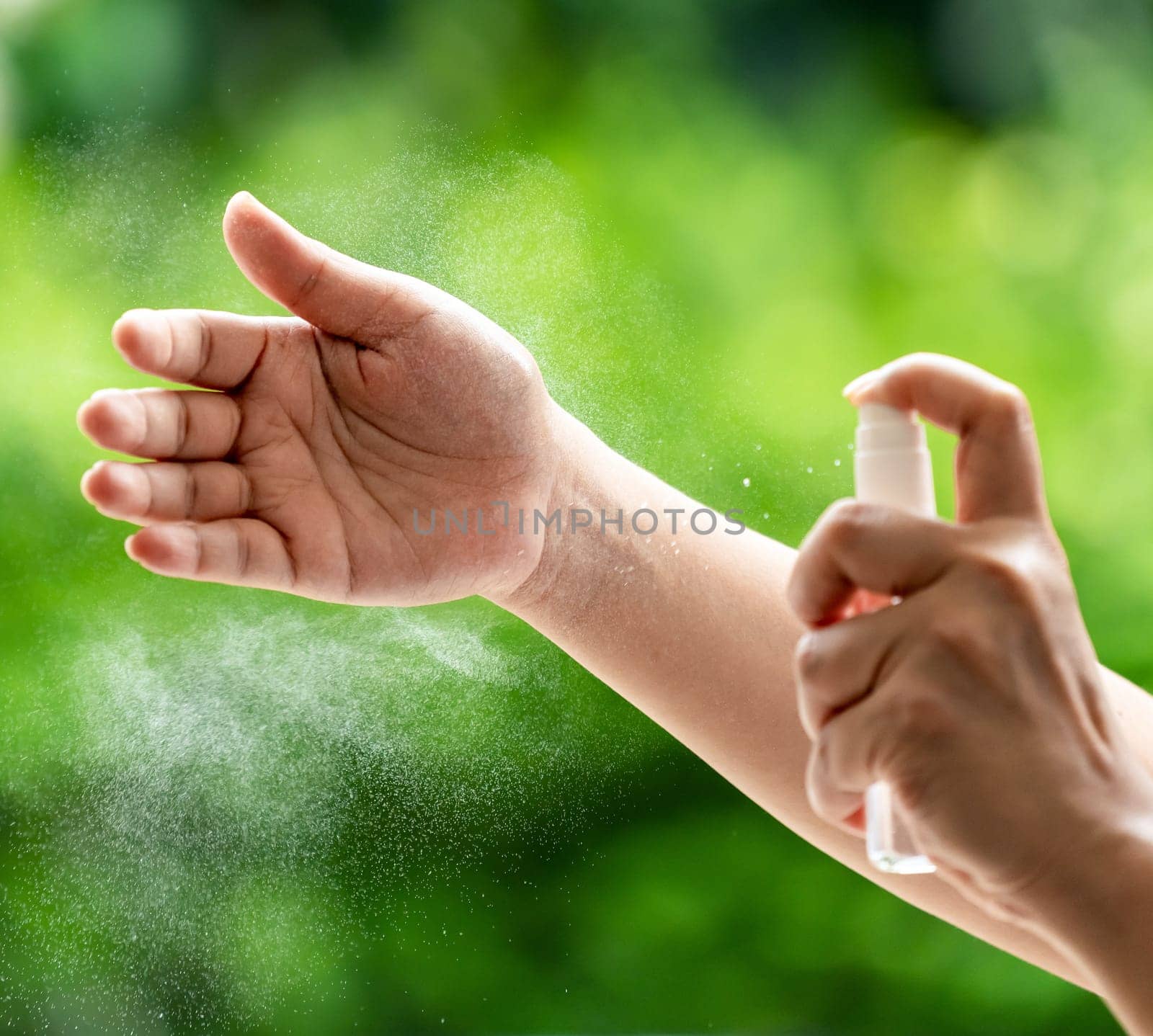 close-up cleaning hand using alocohol spray Hand sanitazer from bottle spraying, disinfection for safety prevent and protect from infection of virus and germ Covid-19 coronavirus world pandemic.