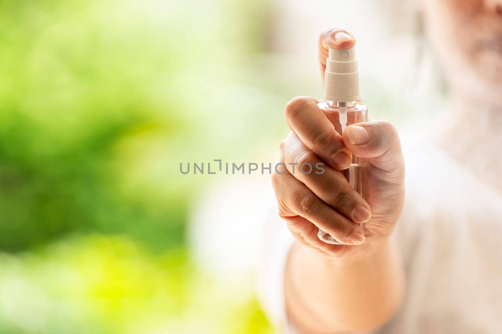 close-up Hand push on alocohol spray hand sanitizer bottle and spraying, disinfection for safety prevent and protect from infection of virus and germ Covid-19 coronavirus world pandemic.