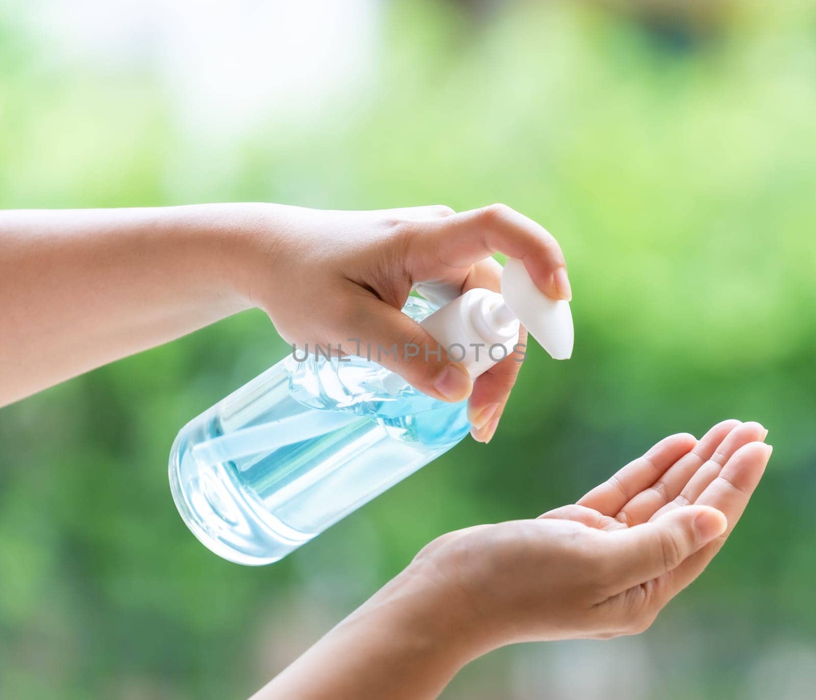 close-up cleaning hand using alocohol gel hand sanitizer waterless in pump bottle, disinfection for safety prevent and protect from infection of virus and germ Covid-19 coronavirus world pandemic.