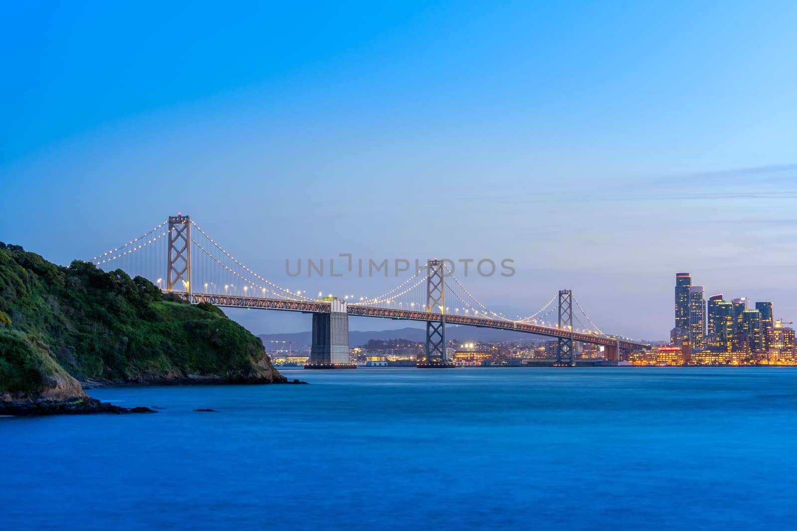 Beautiful sunset with Bay bridge and San Francisco Bay landscape in North California USA West Coast of Pacific Ocean, San Francisco United States Landmark Travel Destination cityscape concept.