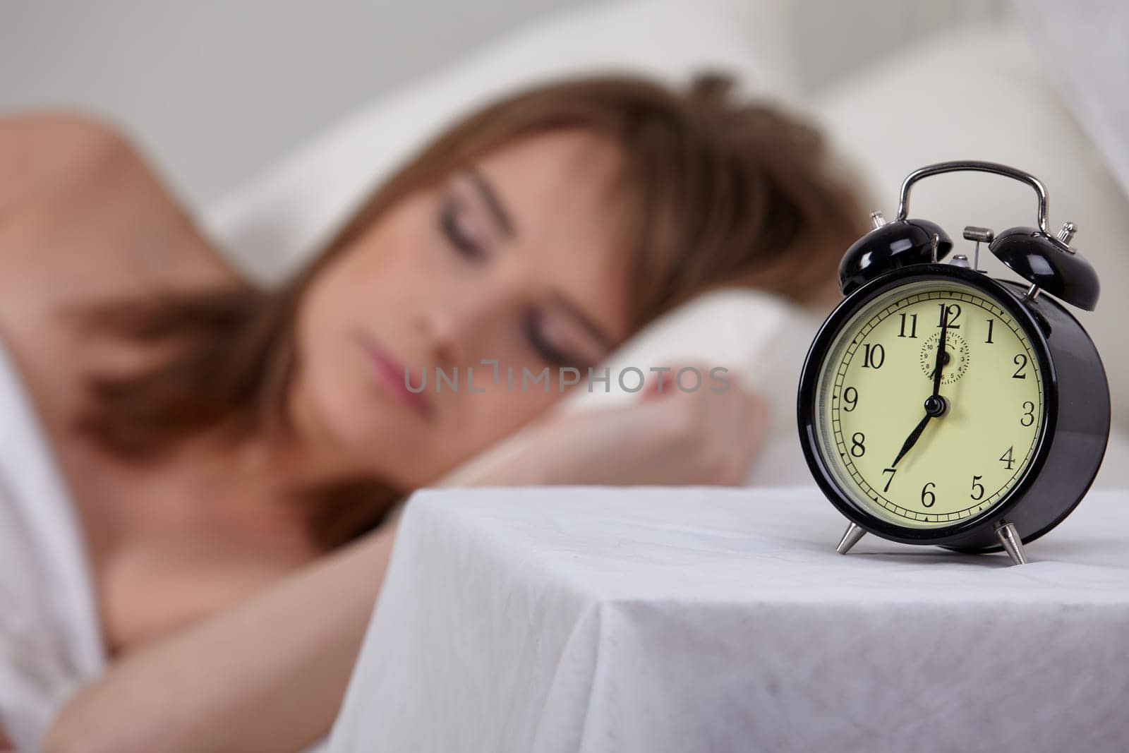Portrait of beautiful young woman sleeping in bed at home.