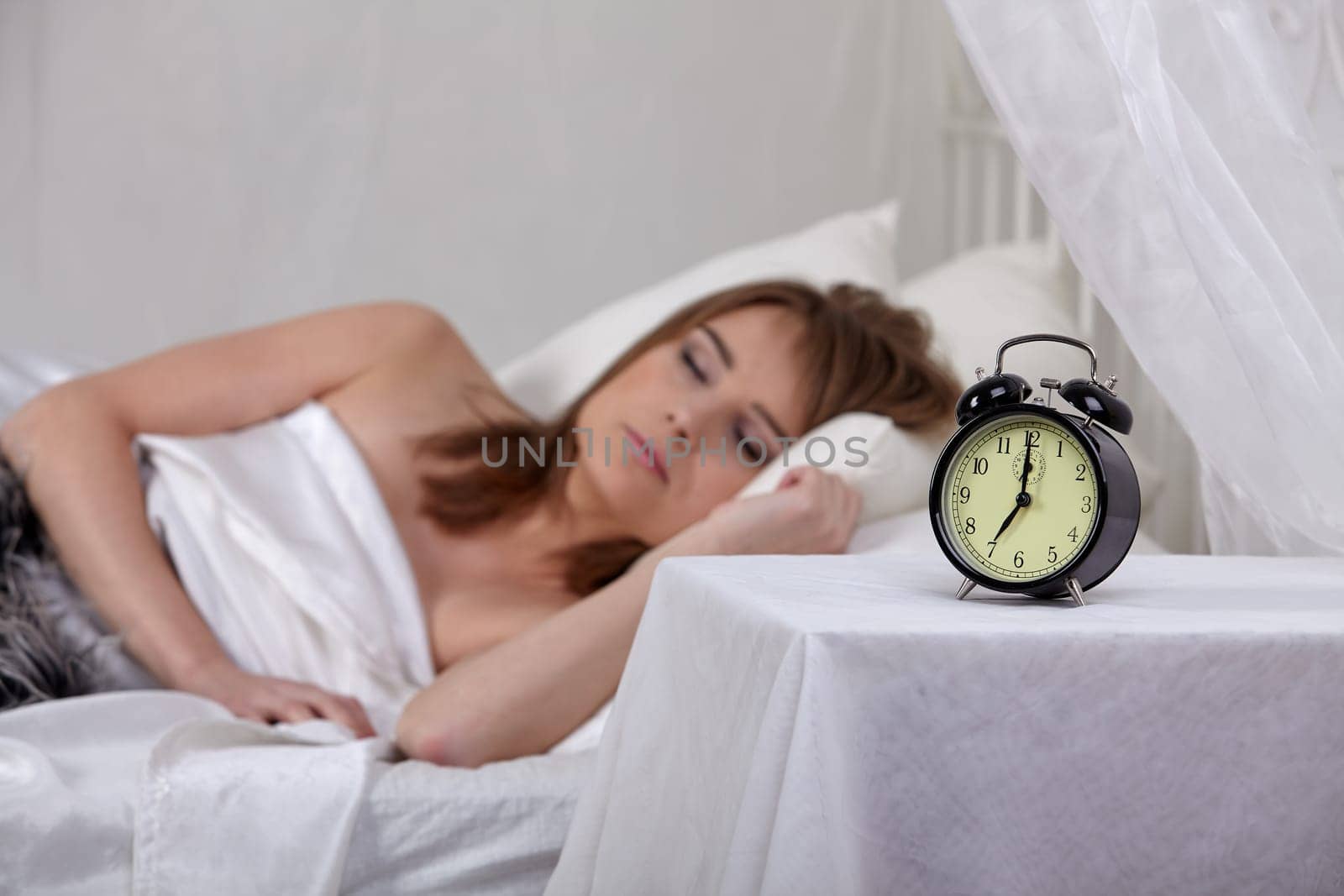 Portrait of beautiful young woman sleeping in bed at home.