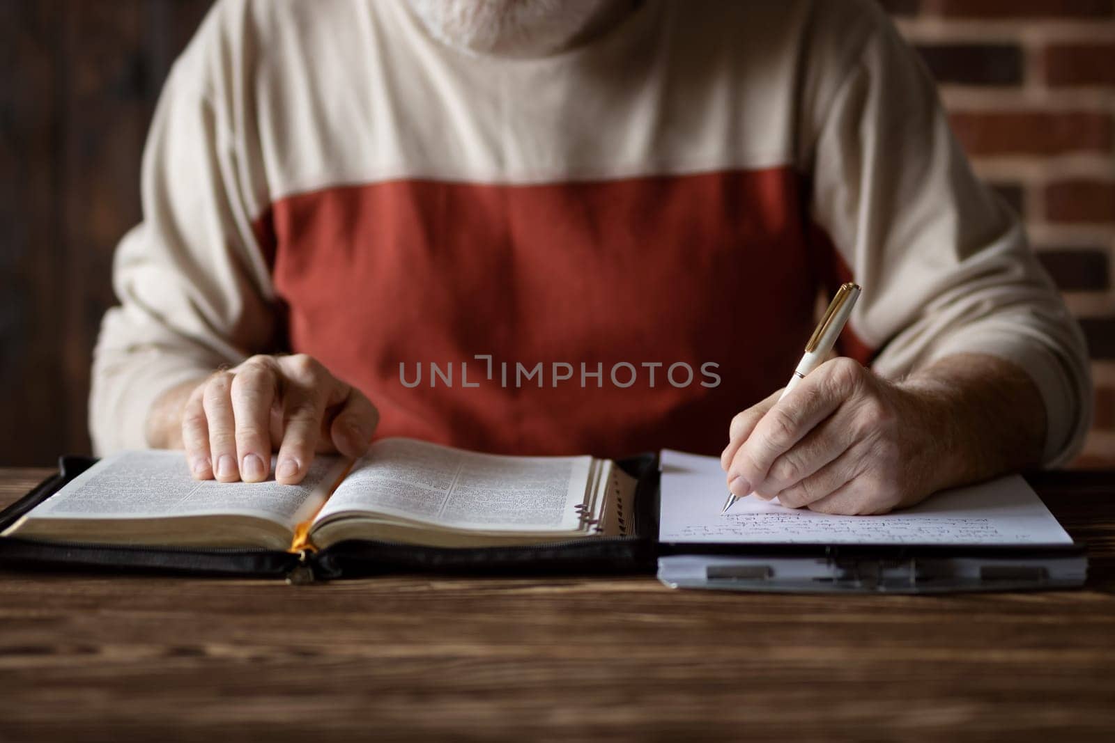 Bible study following the word of Scripture and copying it on paper. Taking notes and study of the Holy Bible. Searching for a spiritual subject