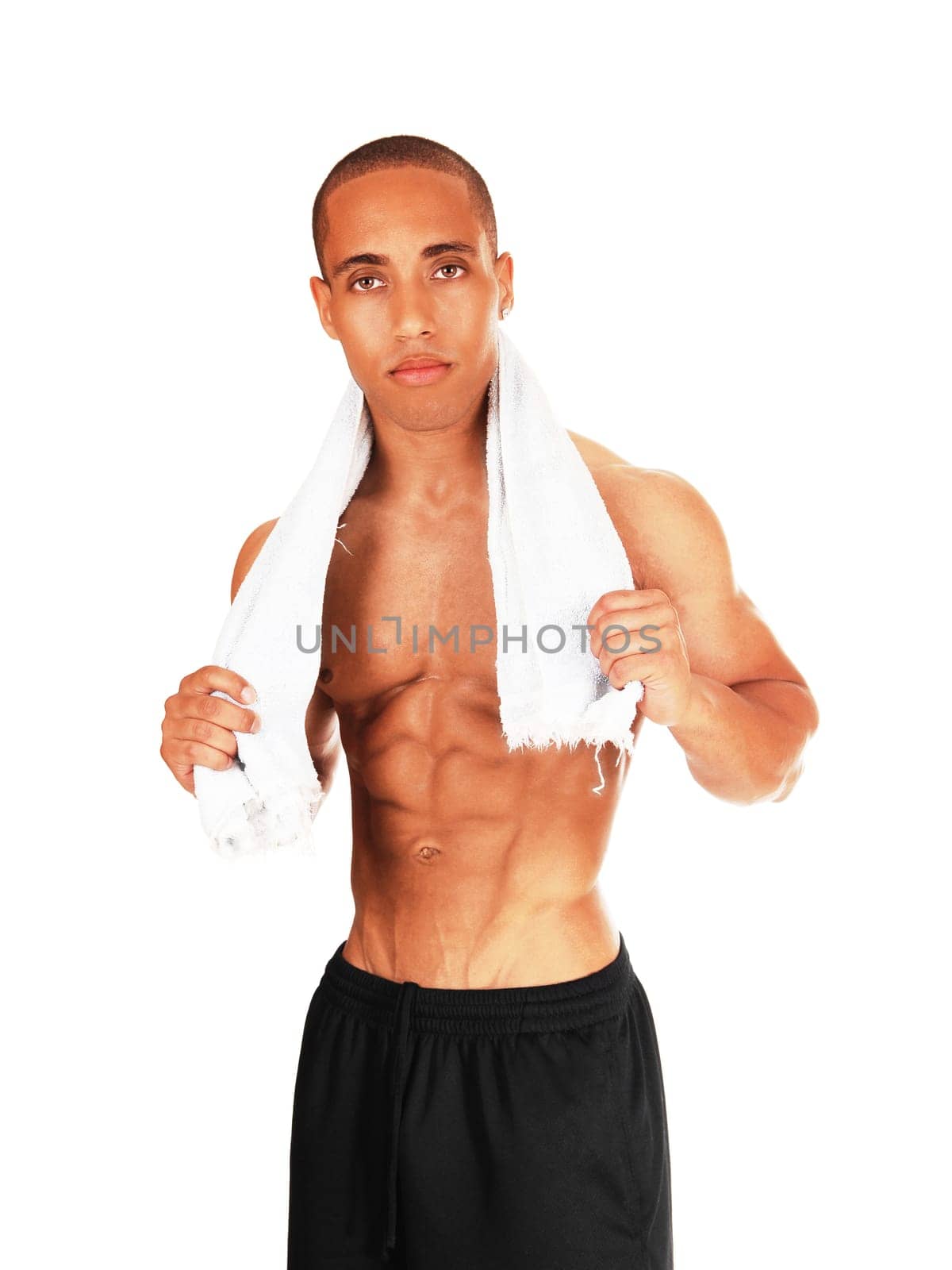 A young man with a great body after an exercise standing with a towel.around his neck, isolated for white background.