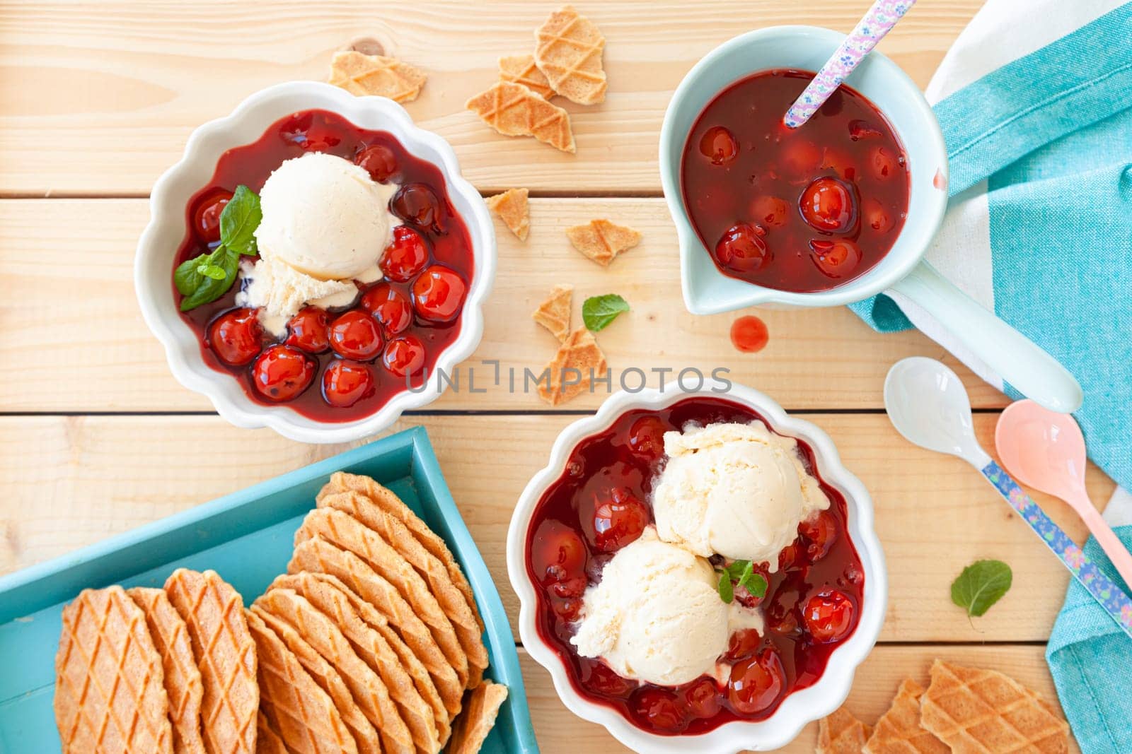 Scoops of vanilla ice cream with cherries and crunchy waffles