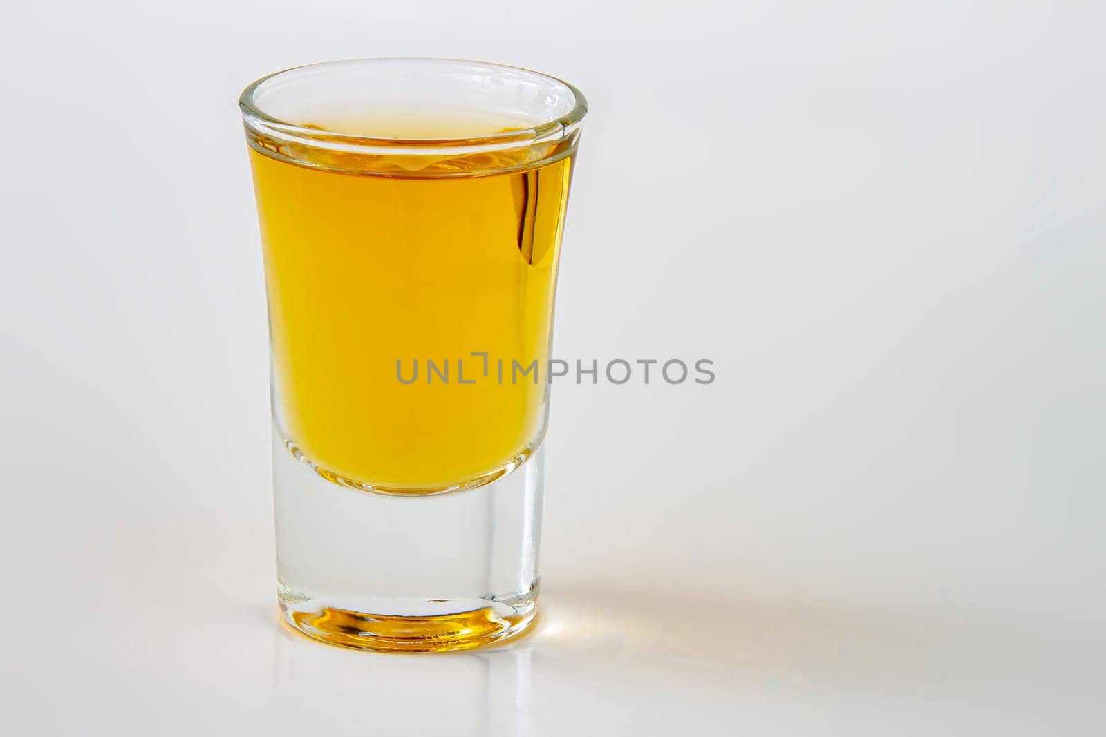 A horizontal view of a liquor shot drink on a white background