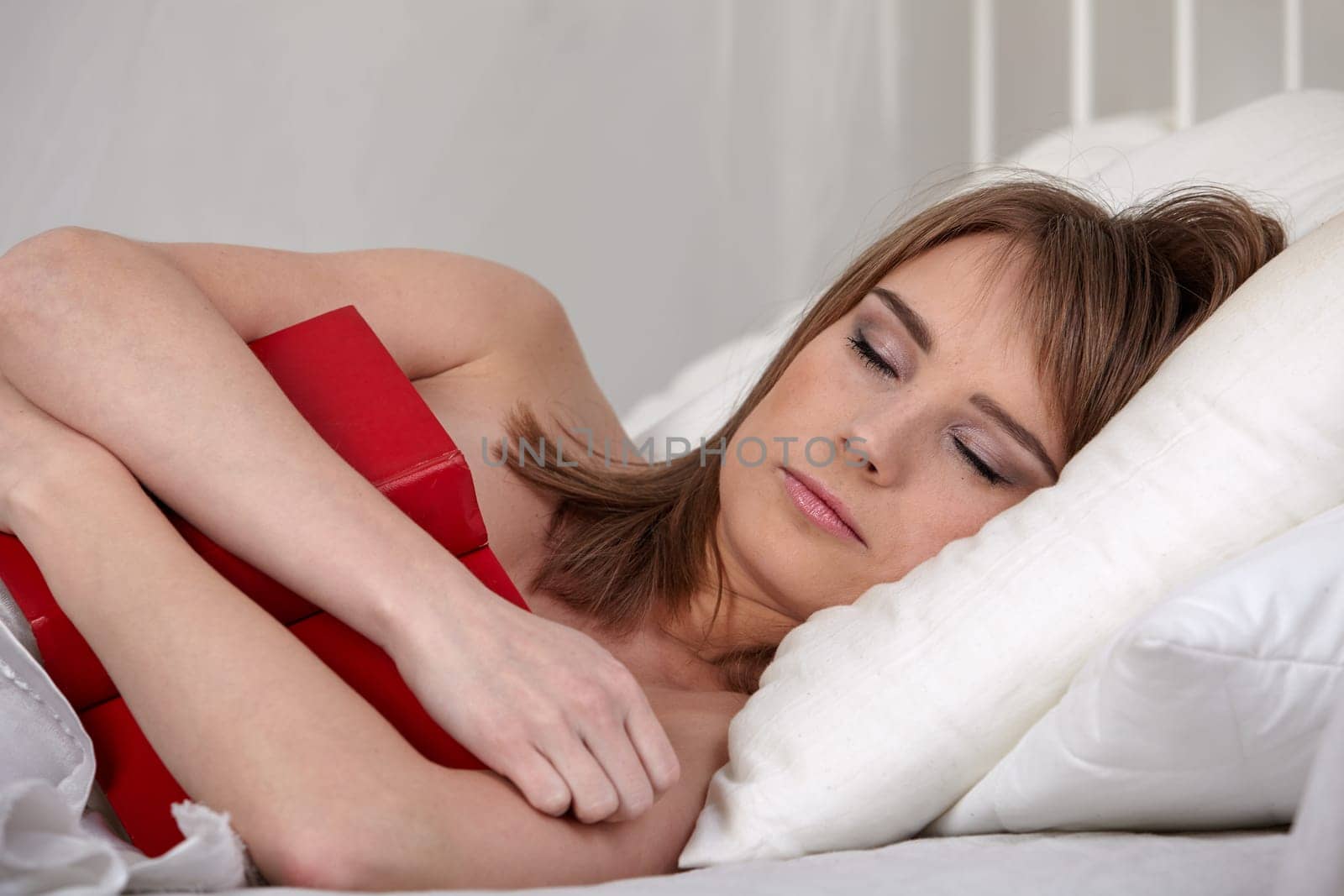 Portrait of beautiful young woman sleeping in  bed at home.