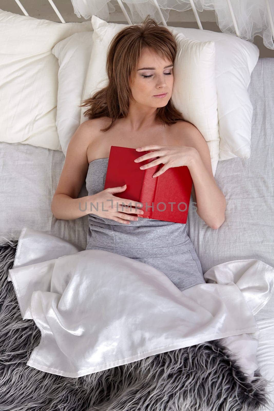 Portrait of beautiful young woman sleeping in  bed at home.