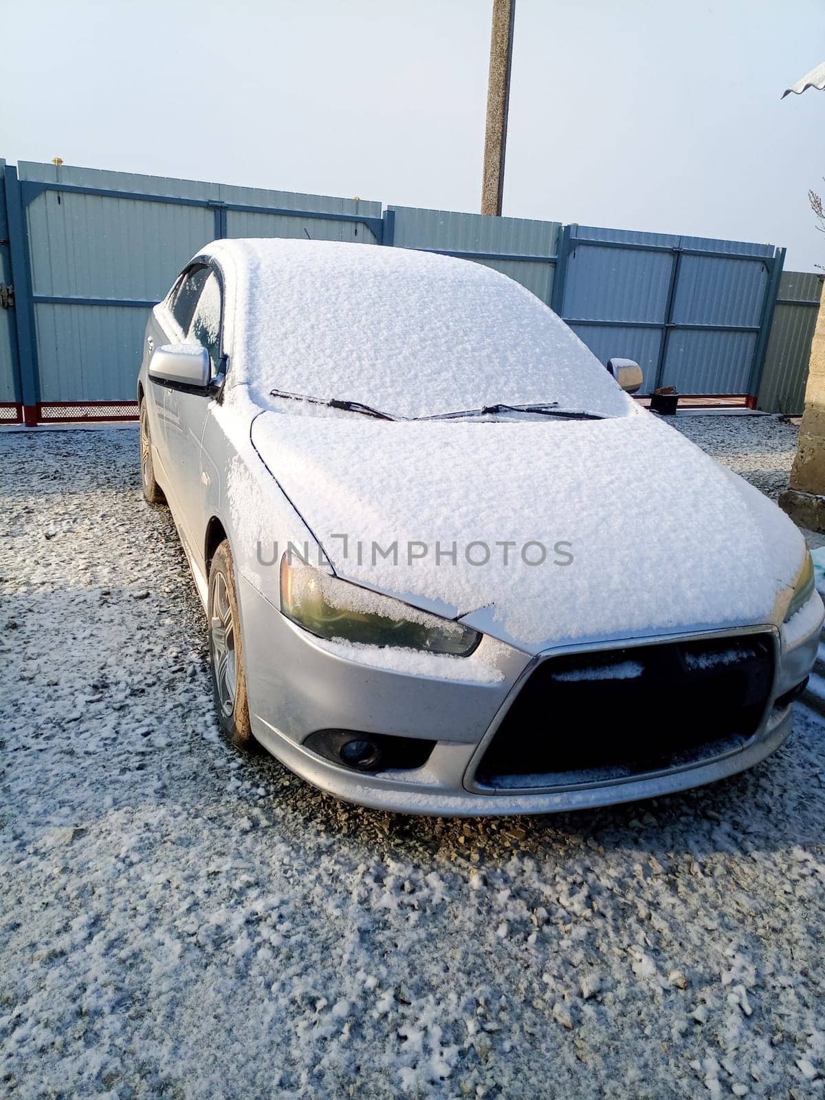 Snow covered car. Morning snow in the yard by car.