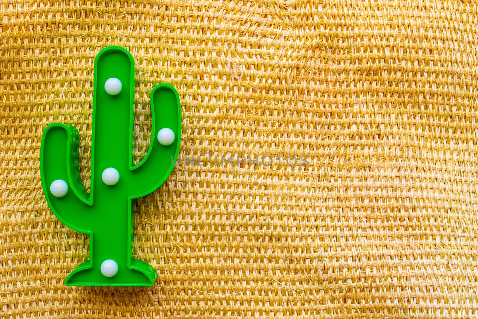 Cinco de Mayo background. A cactus on a straw rural bag background texture