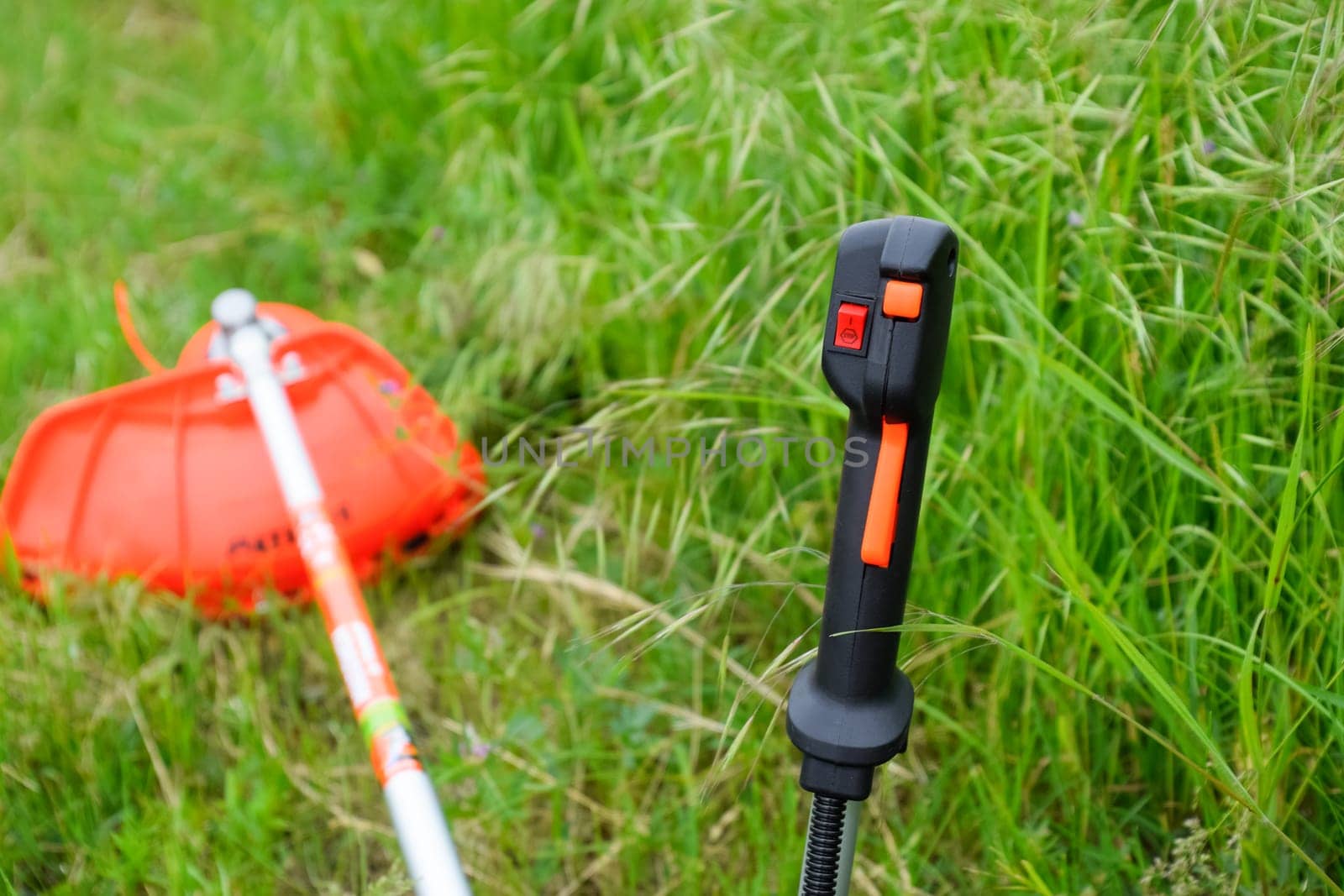 Knob with trimmer controls. Gas trimmer, equipment controls. Trimer gascosis with a leaf for mowing grass and shrubs.