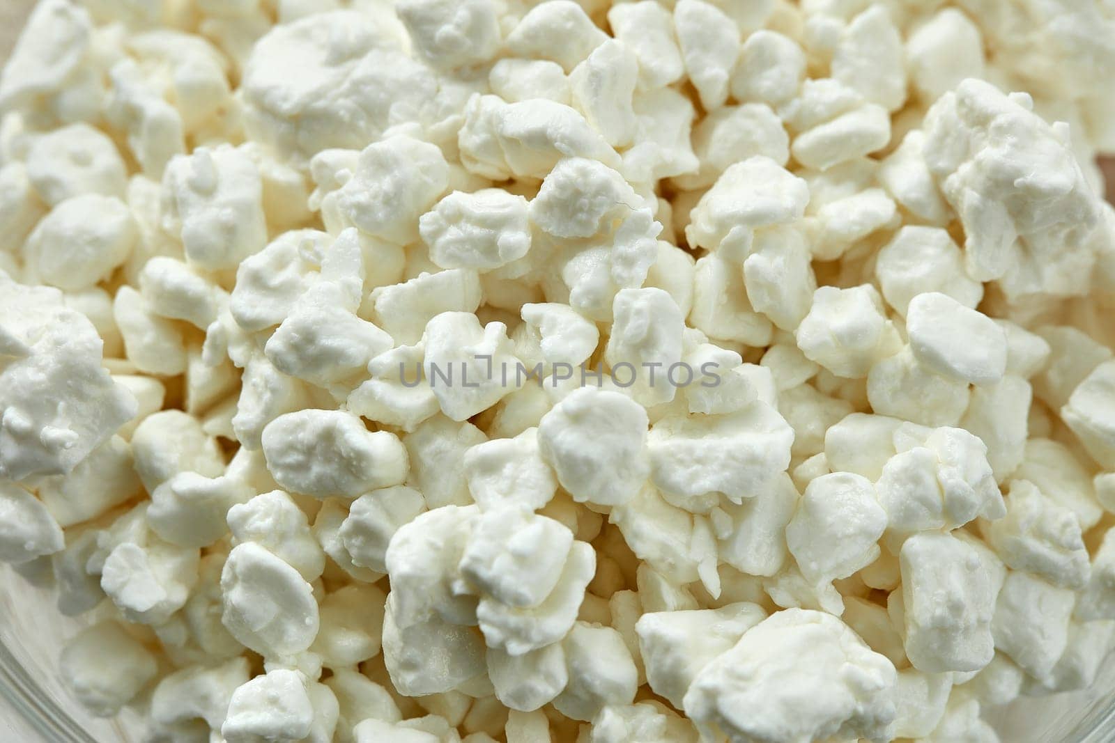 Background from fresh village cottage cheese. Healthy food. Close- up. Dietary product. Dairy product. Fitness food