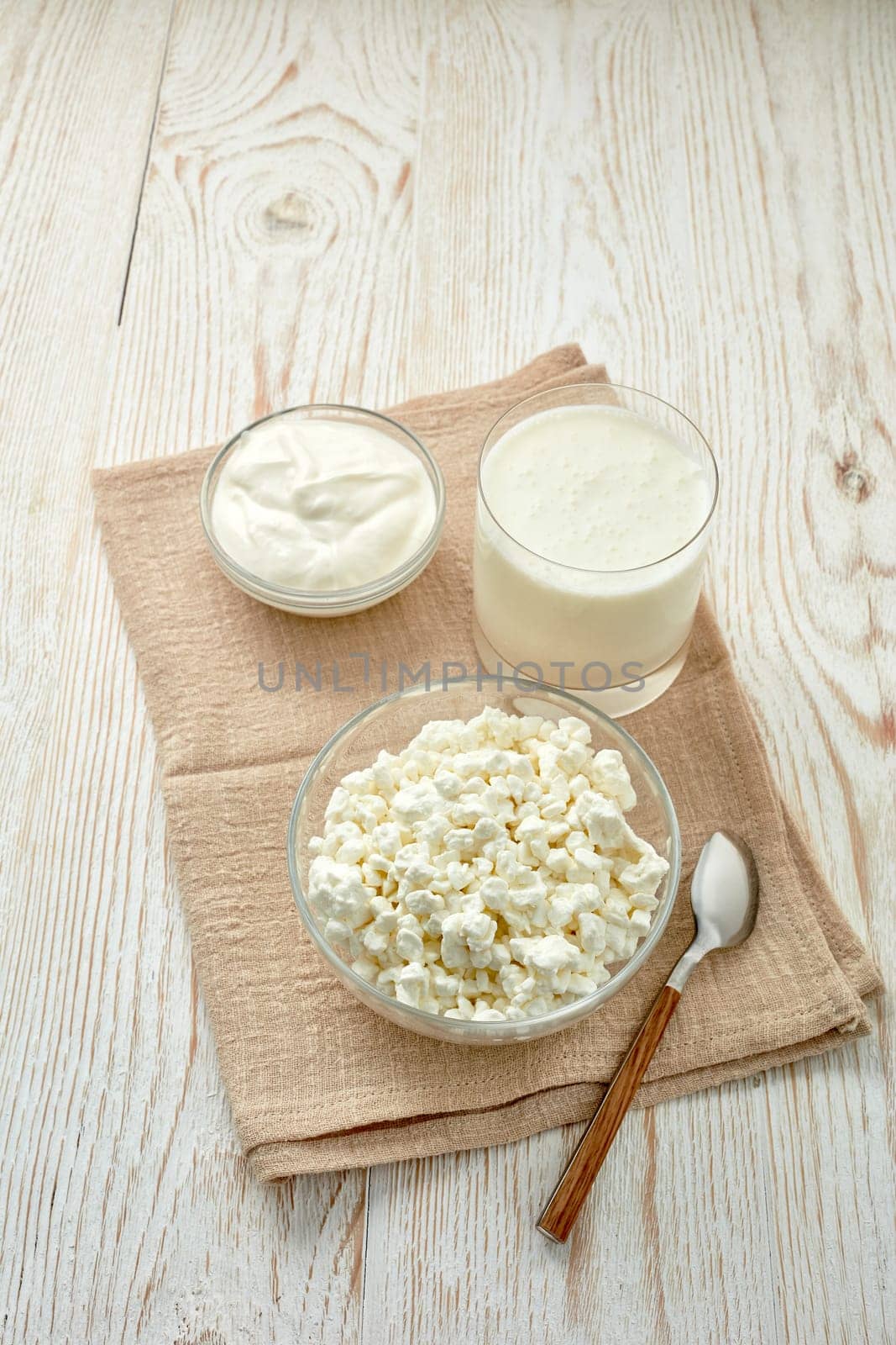 Fresh village cottage cheese and sour cream in glass bowsl and glass with  yogurt. Healthy food. Dietary product. Dairy products.