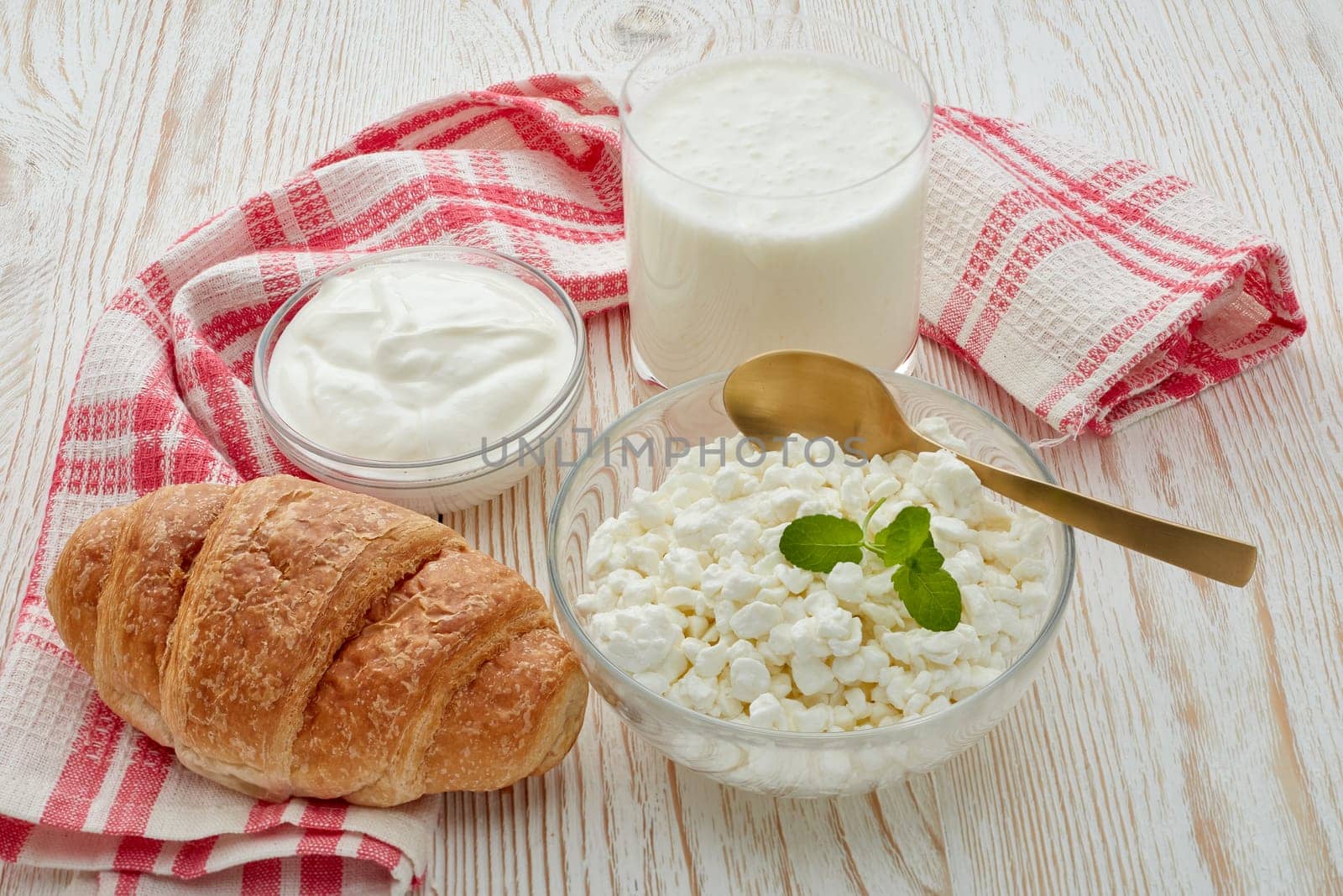 Still life with fresh village cottage cheese, sour cream, yogurt and croissant. Healthy food. Dairy producst. Healthy meal. Dietary product.