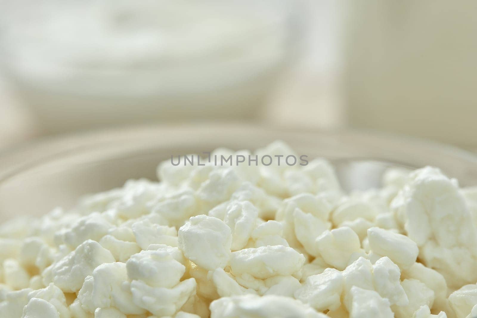 Fresh village cottage cheese in glass bowl. Close- up. Healthy food. Dietary product. Dairy product. Fitness food