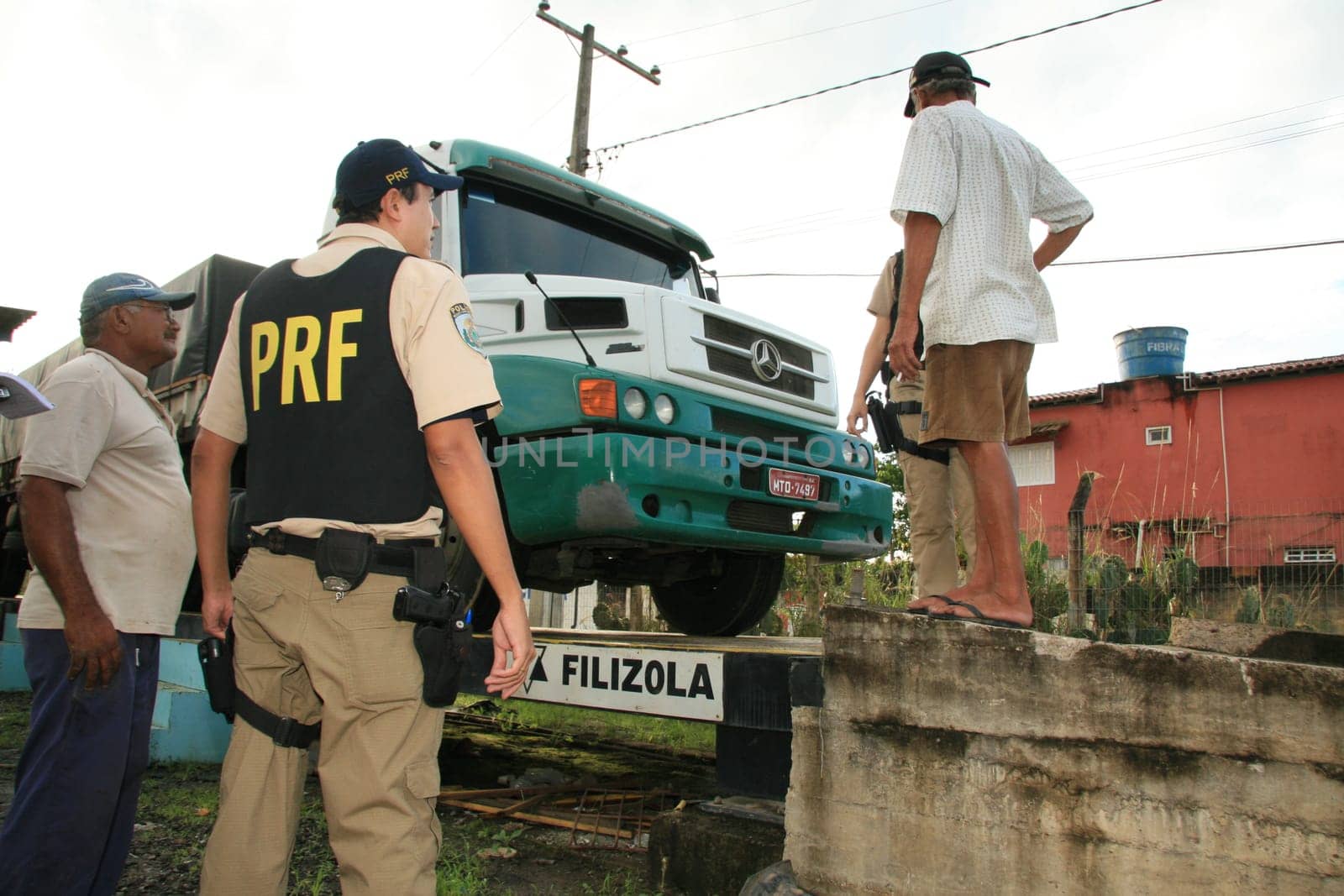 eunapolis, bahia / brazil - may 6, 2009: Federal Highway Police officer spotted during Operation on BR 101 Highway oversees overweight cargo vehicles.