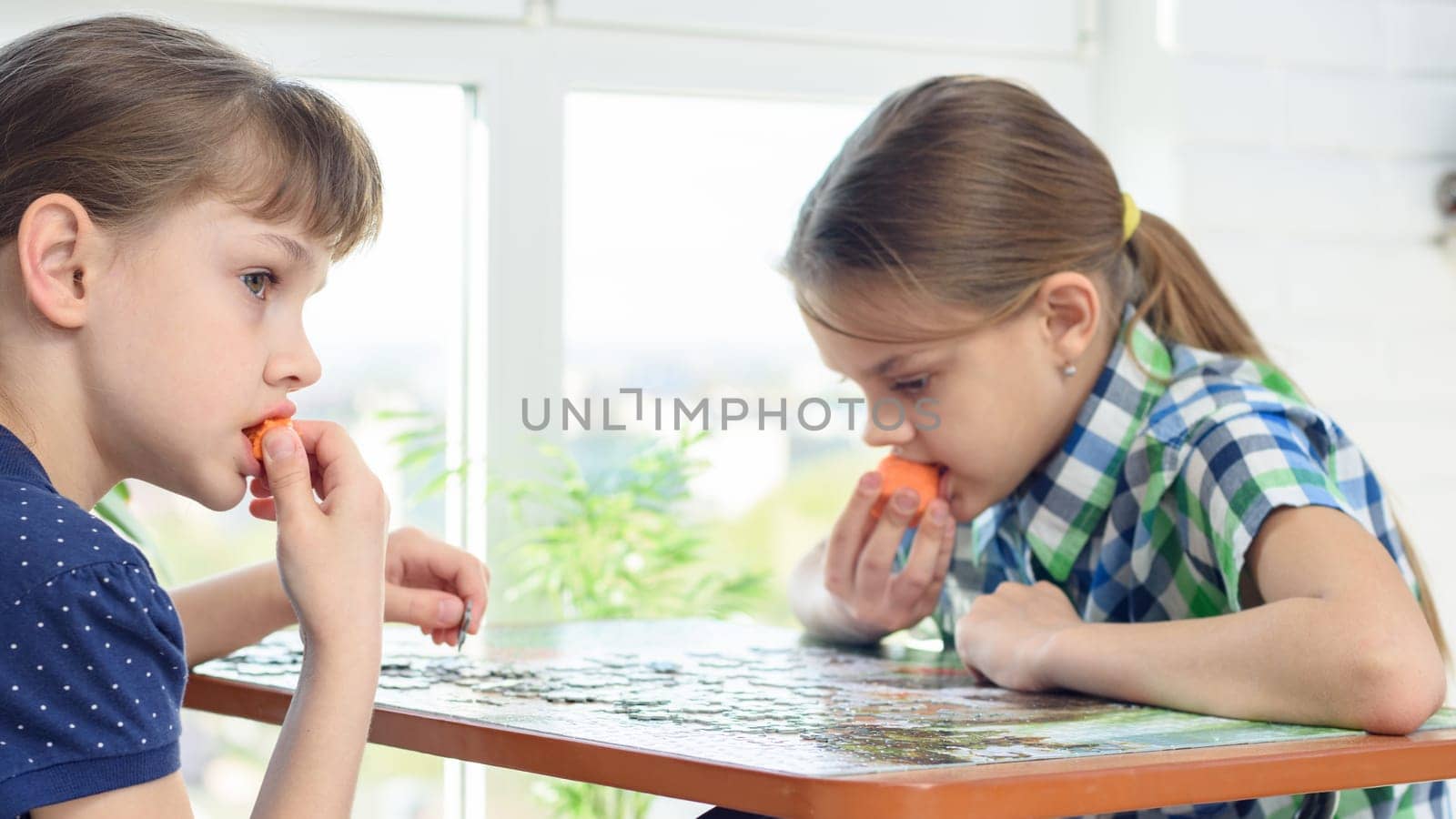 Children collect puzzles and snack on carrots