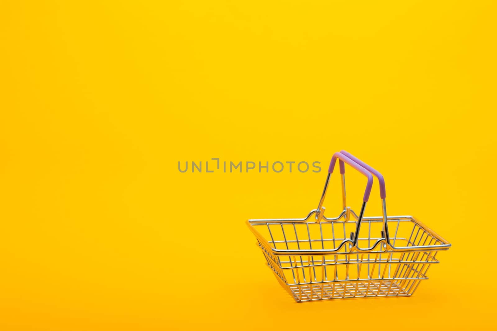 Empty grocery basket on a bright orange background