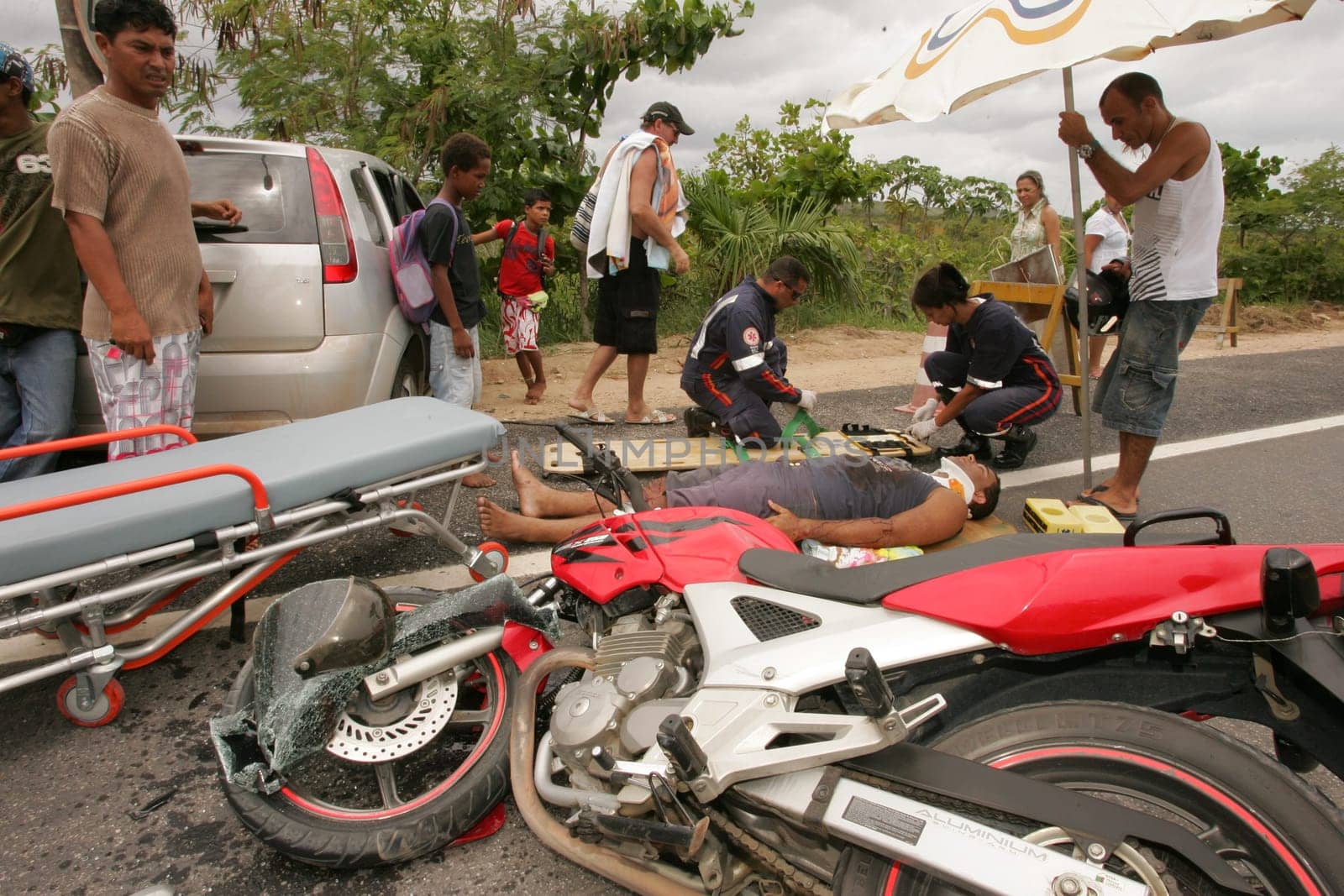 porto seguro, bahia / brazil - december 30, 2010: Samu rescuers service a motorcyclist involved in an accident on the BR 367 highway in Porto Seguro.