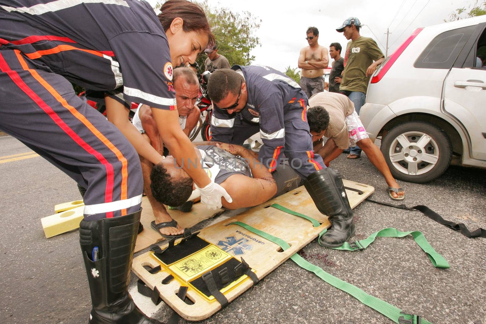 porto seguro, bahia / brazil - december 30, 2010: Samu rescuers service a motorcyclist involved in an accident on the BR 367 highway in Porto Seguro.