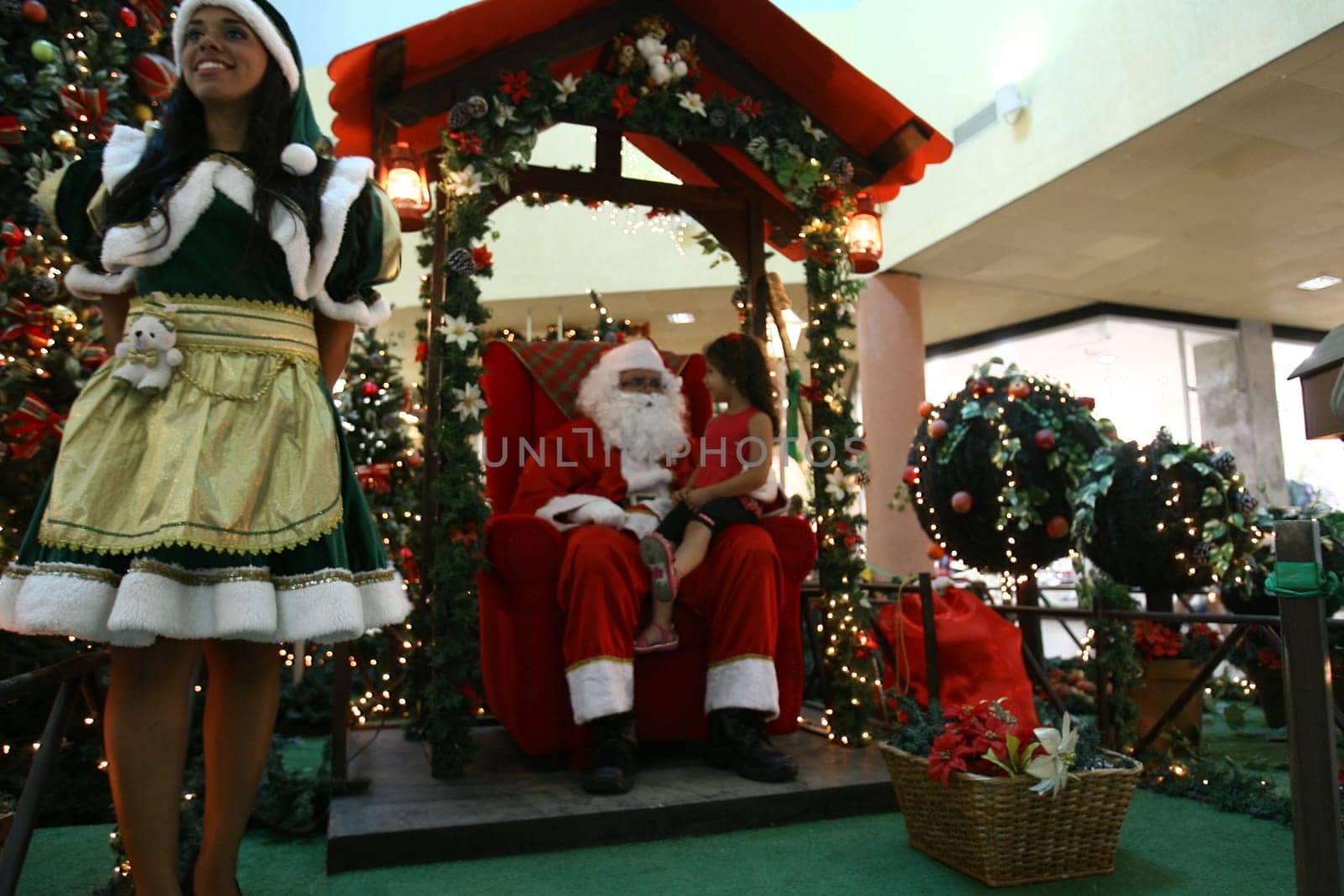 itabuna, bahia / brazil - december 5, 2011: Sitting on his throne Santa receives children at Shopping Jequitiba, in the city of Itabuna.