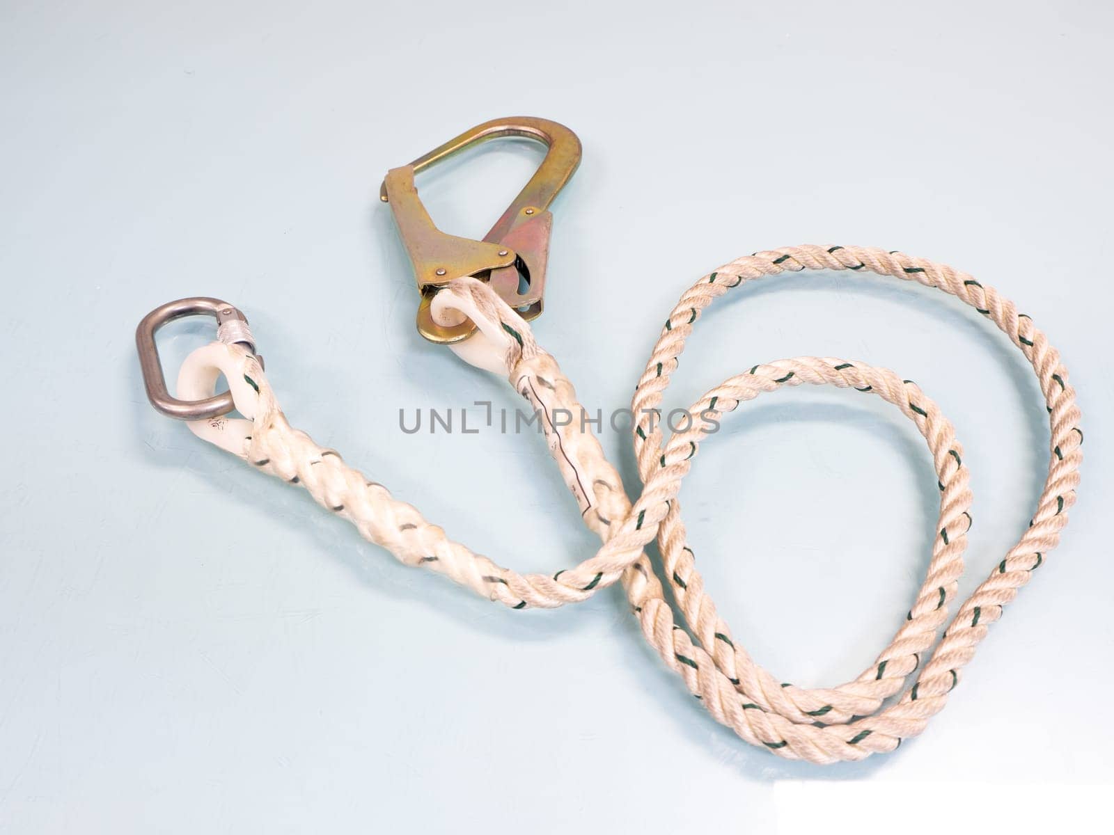 Figure eight knot with carabiner. Silver carabiner with lock andrope isolated on white background.