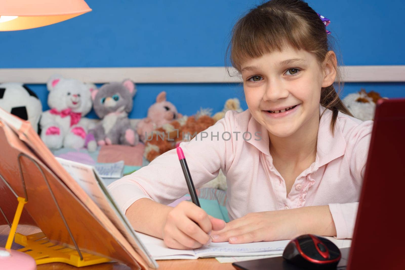 Portrait of a cheerful student doing homework at home