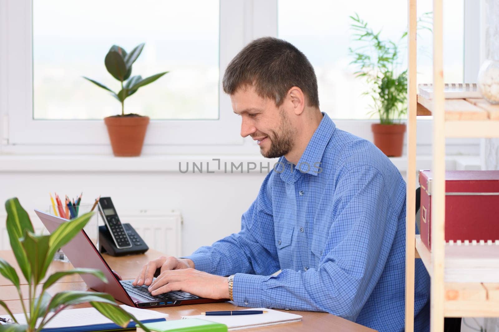 Successful businessman works in the computer at the office