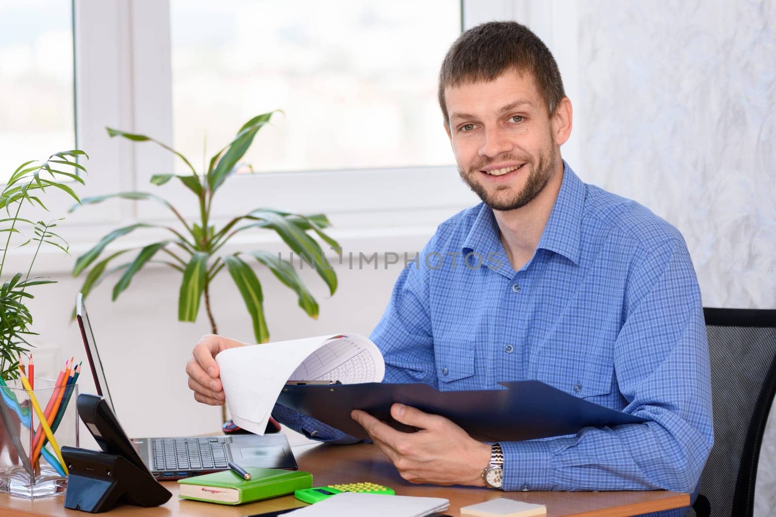 Successful male businessman at workplace in office