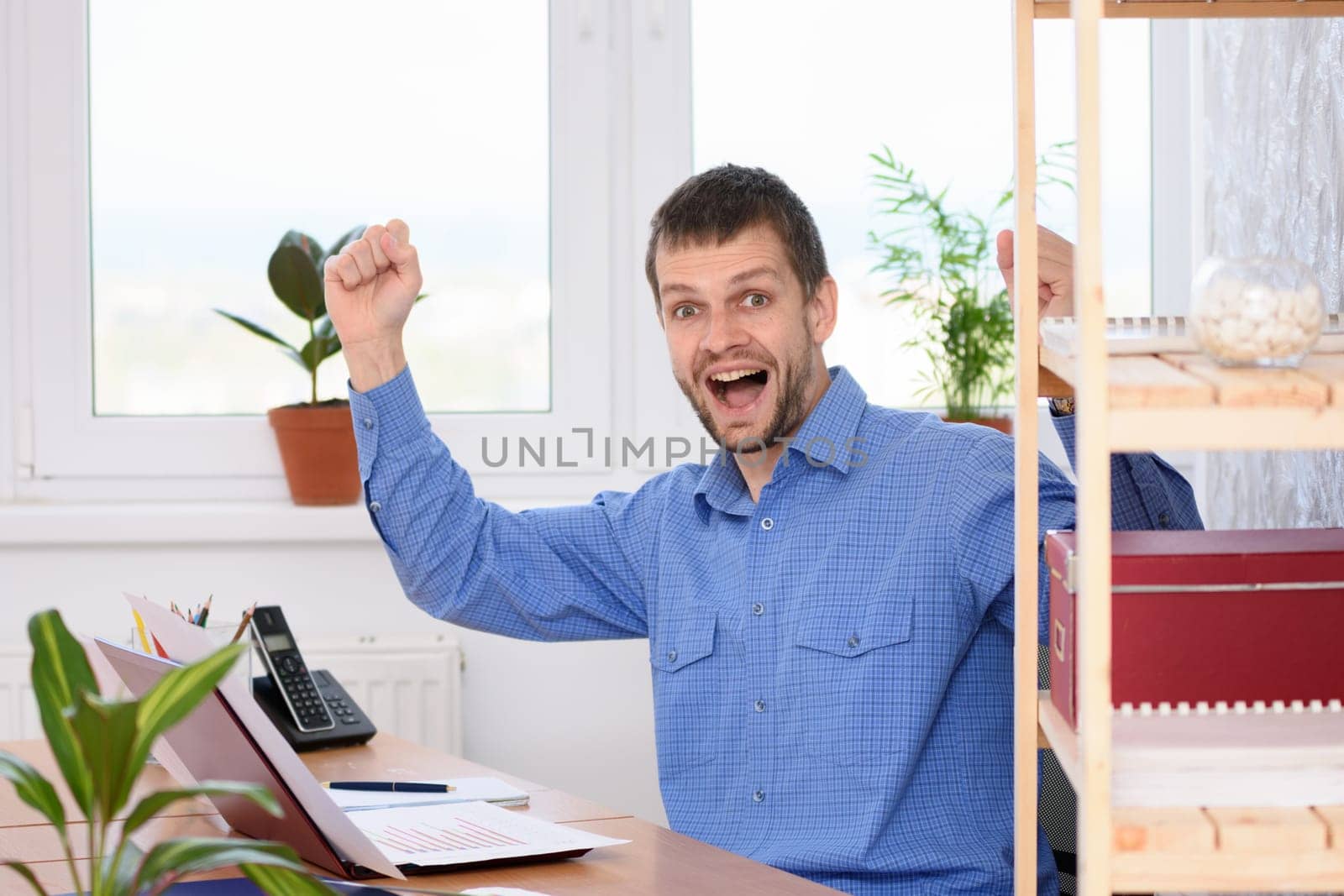 Businessman in the office is very happy about a successful deal