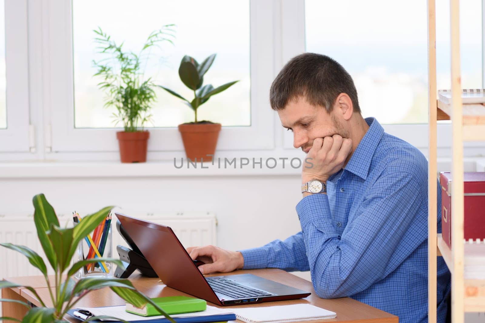 Office specialist working in a laptop at his workplace