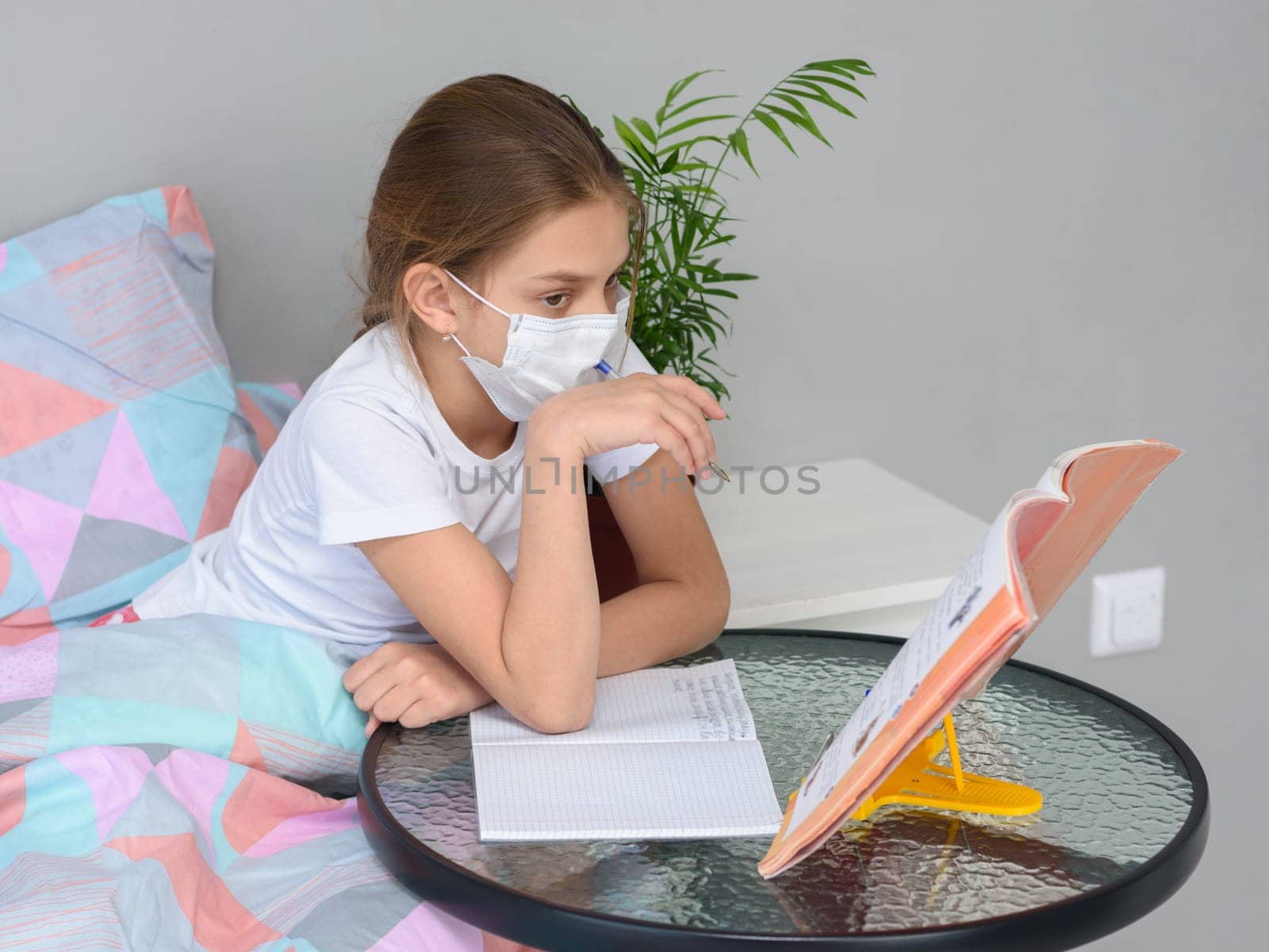 A girl in quarantine performs school homework