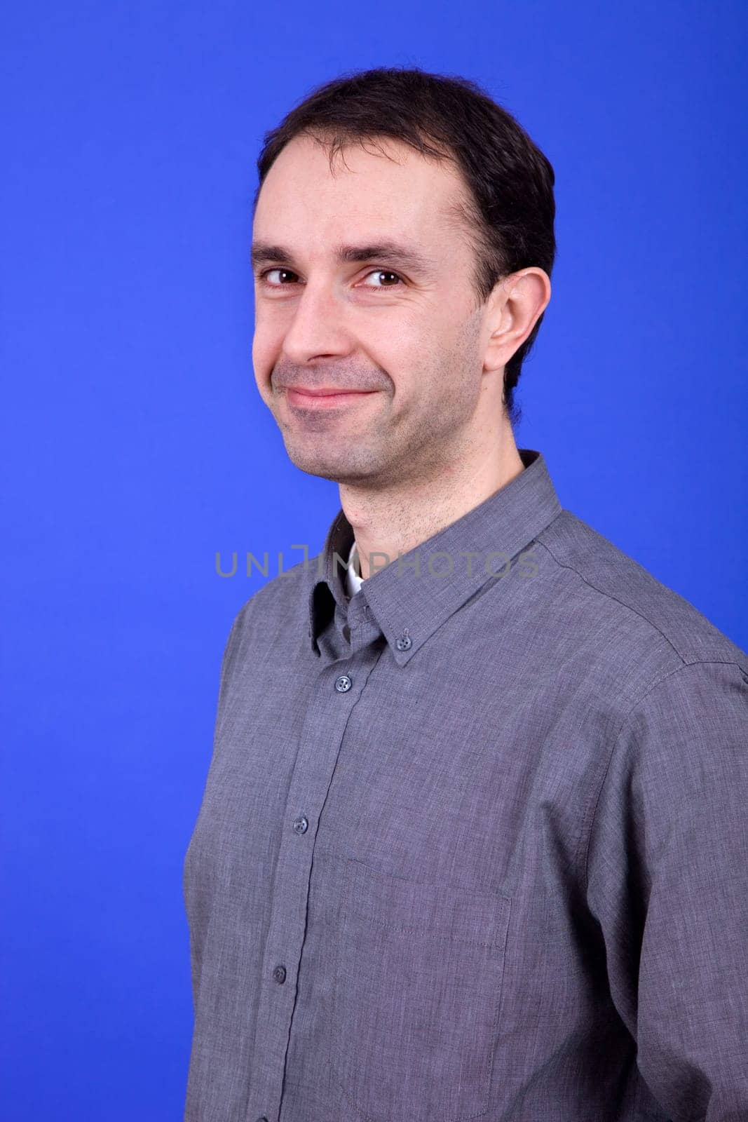 an young man portrait over a blue background
