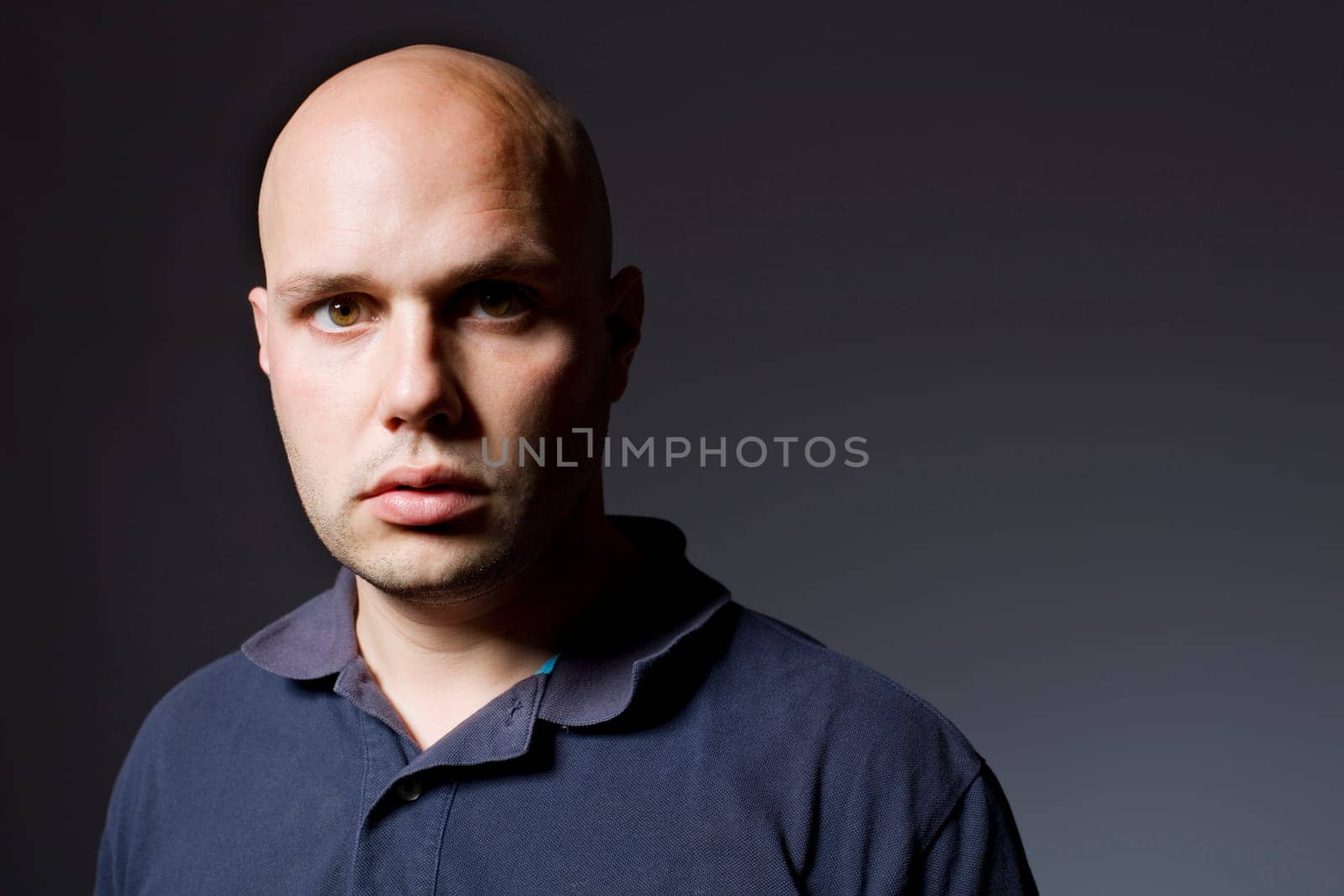 Portrait of young man thinking on a black background